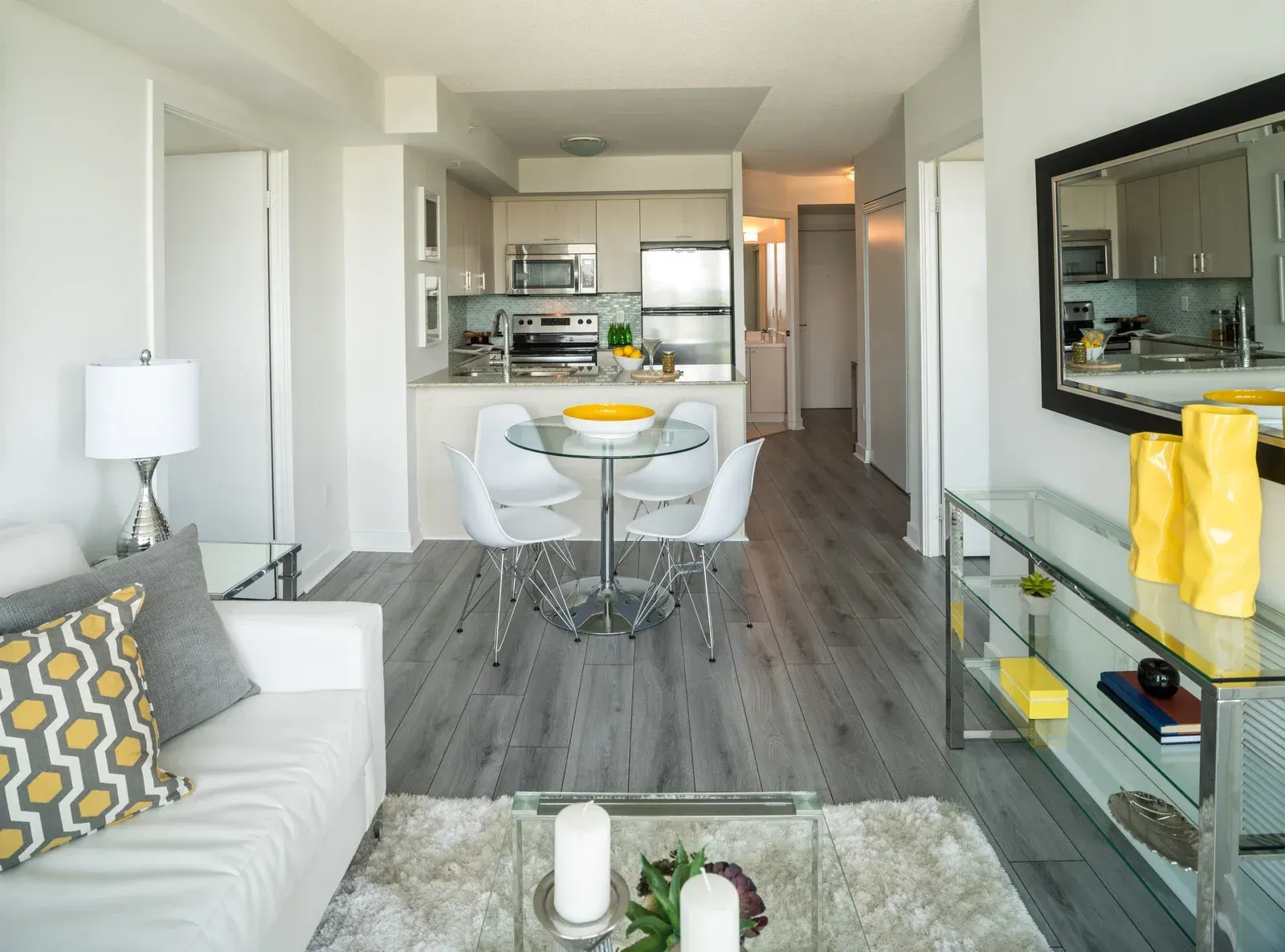 A living room with a couch a table and chairs