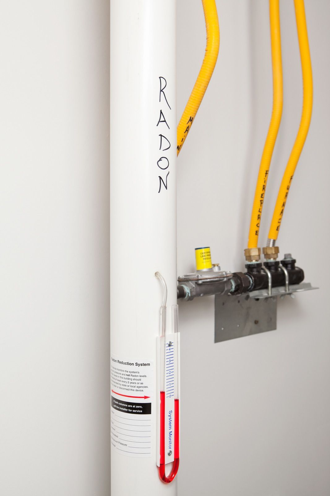 A white water heater with radon written on it