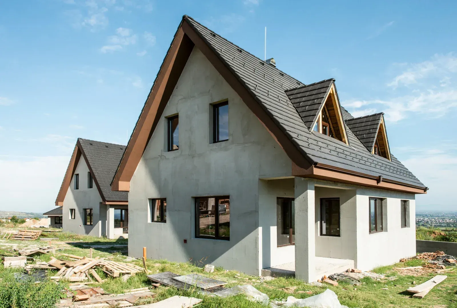 A large concrete foundation for a house is being built.