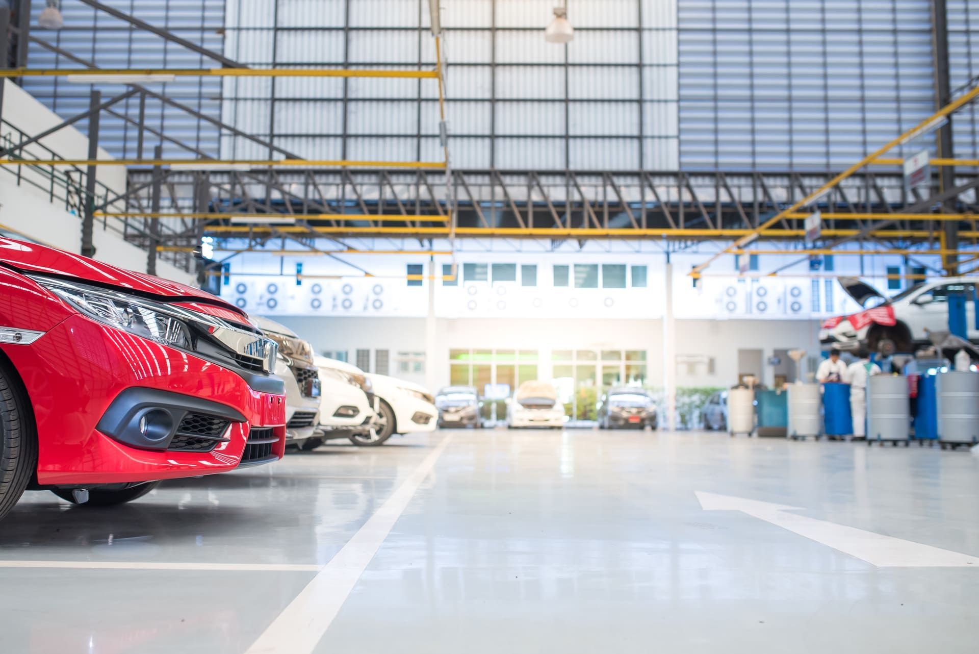 Electric car repair lift in service lay on epoxy floor in new car factory service