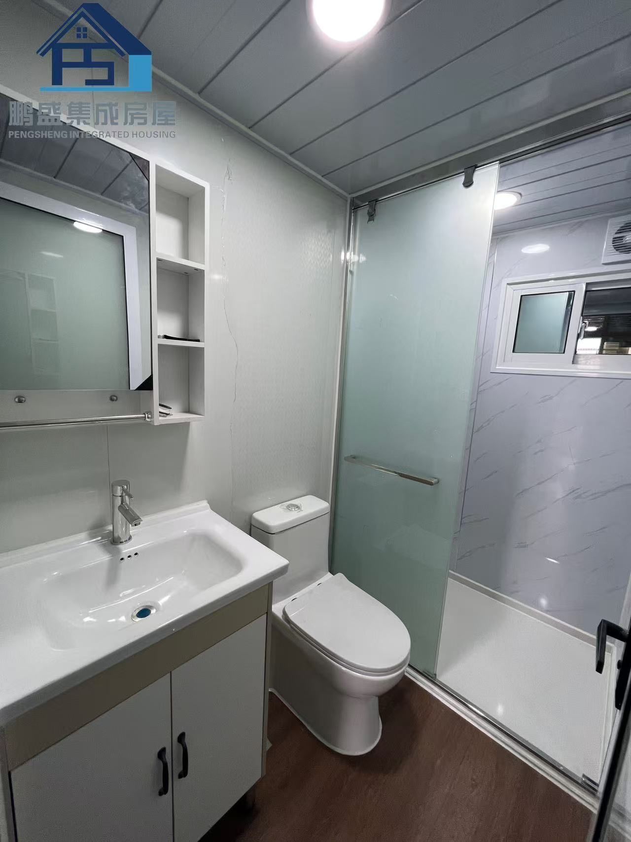 Bathroom interior with white fixtures, a sliding shower door, and a vanity. — Expandable Housing in Inala, QLD