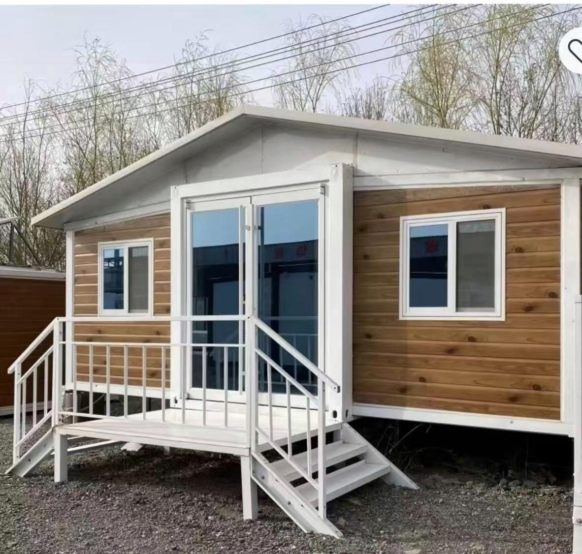 Small cabin with wood paneling, white trim, glass doors, and a small porch. — Expandable Housing in Inala, QLD