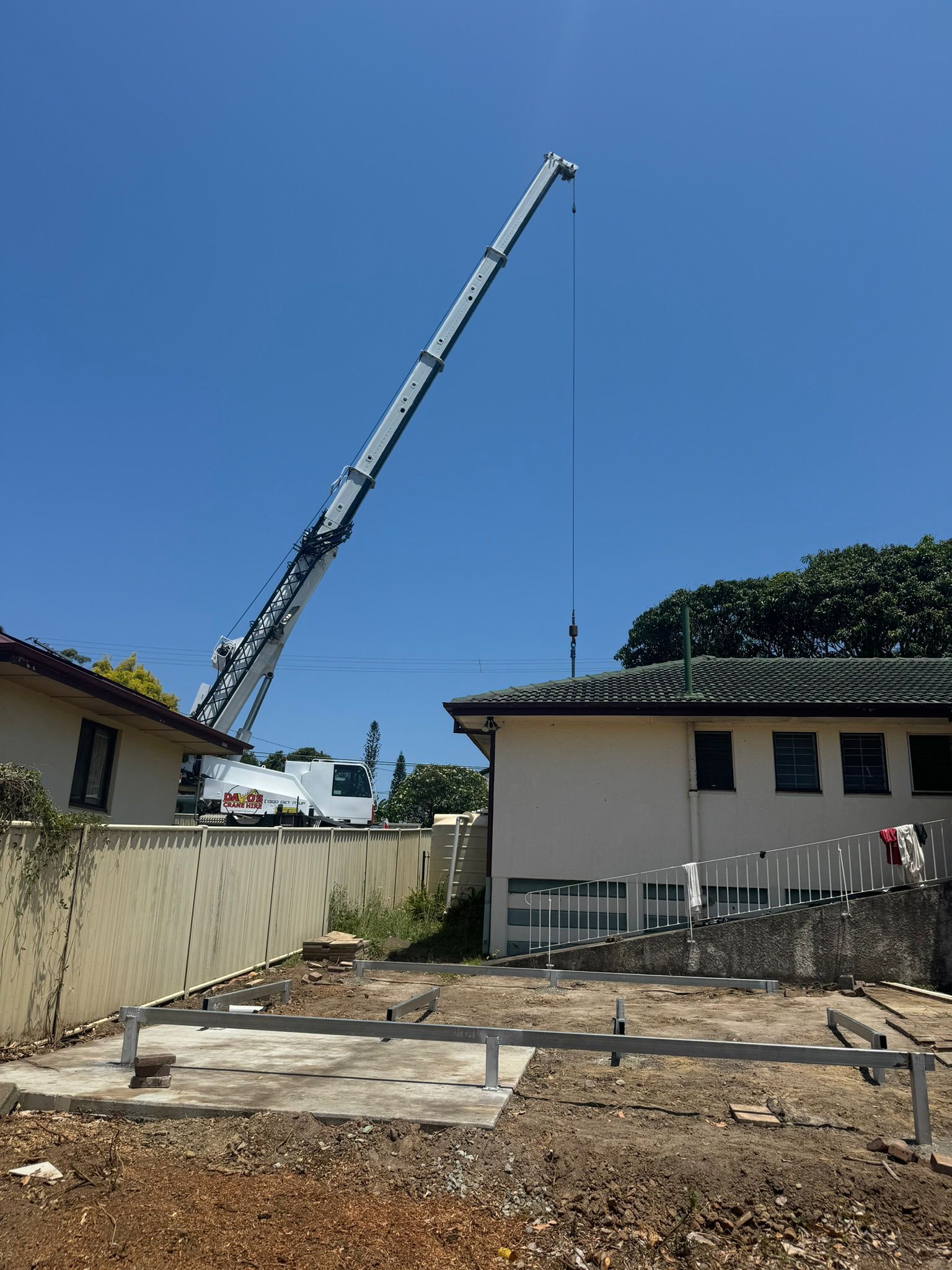 Crane Over Construction Site Near Houses on a Sunny Day — Expandable Housing in Inala, QLD