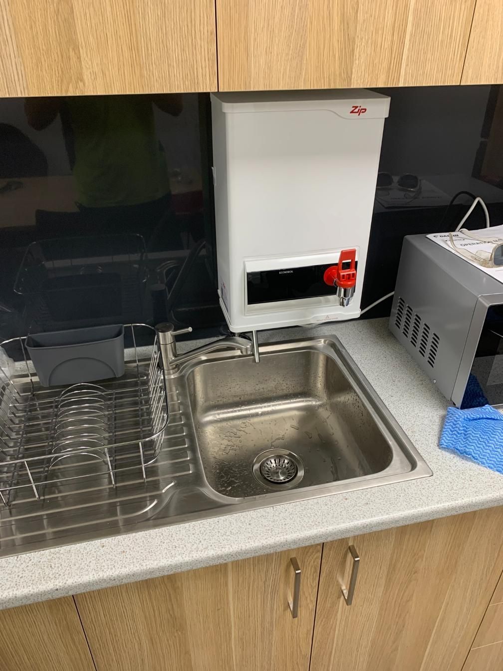 White Water Dispenser Above a Stainless Steel Sink in a Kitchen Area — Huddo's Plumbing Service in Wallalong, NSW