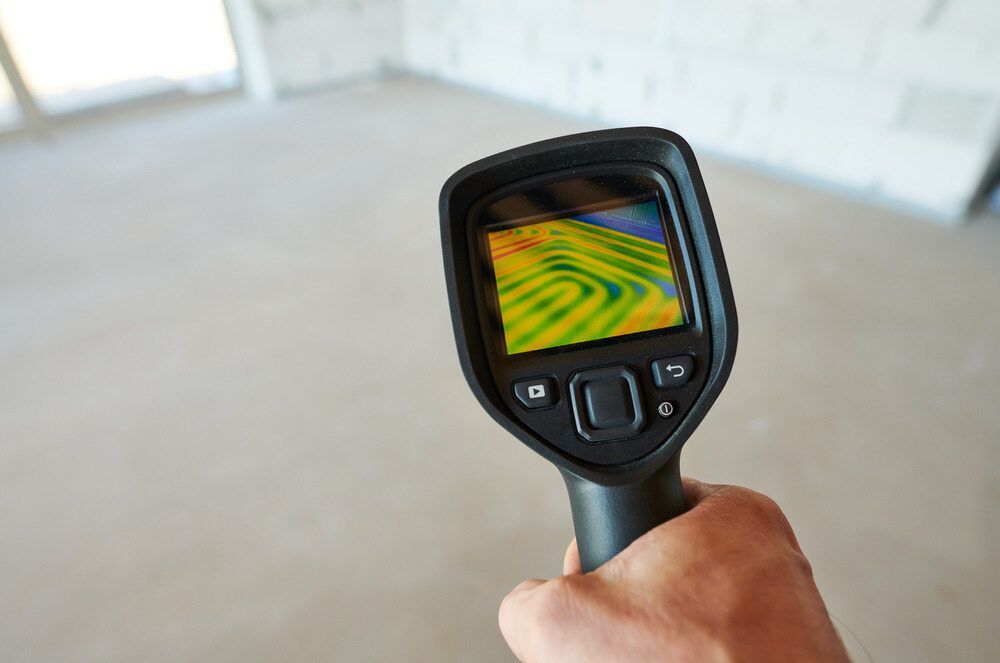 Hand Holding a Thermal Imaging Camera, Displaying a Colorful Heat Map — Huddo's Plumbing Service in Wallalong, NSW