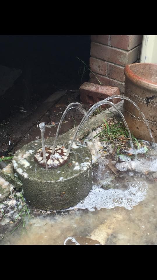 Water Fountain With Arching Jets, Overflowing Concrete Base — Huddo's Plumbing Service in Hunter Valley, NSW