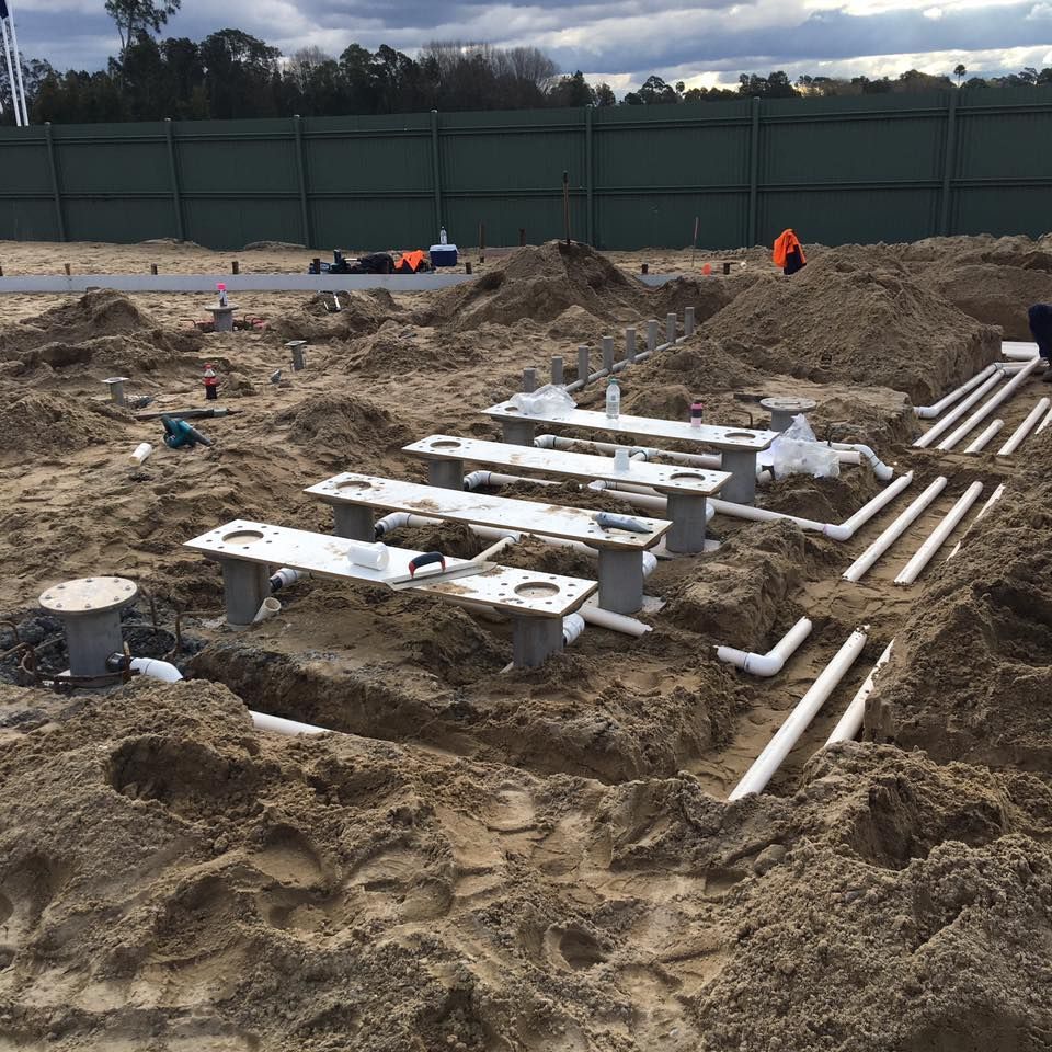 Construction Site With Buried Pipes and Concrete Structures in the Sandy Soil — Huddo's Plumbing Service in Wallalong, NSW
