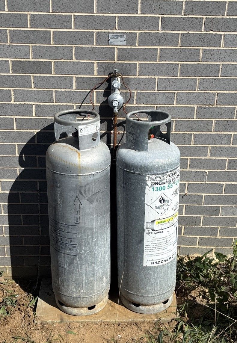 Plumber Adjusts Valve on Copper Pipes Connected to a Pressure Gauge — Huddo's Plumbing Service in Wallalong, NSW