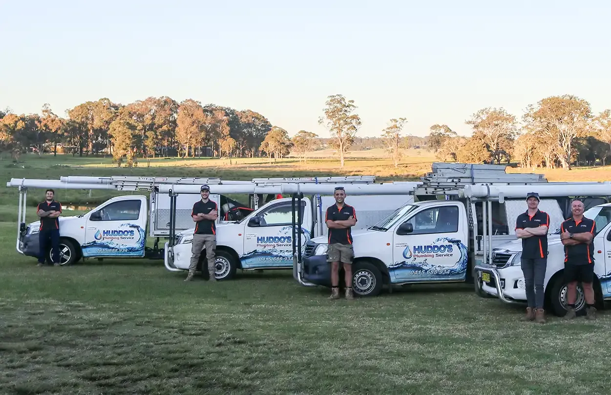 White Work Truck With Huddo's Plumbing Branding Parked Near a Pond at Sunset — Huddo's Plumbing Service in Wallalong, NSW