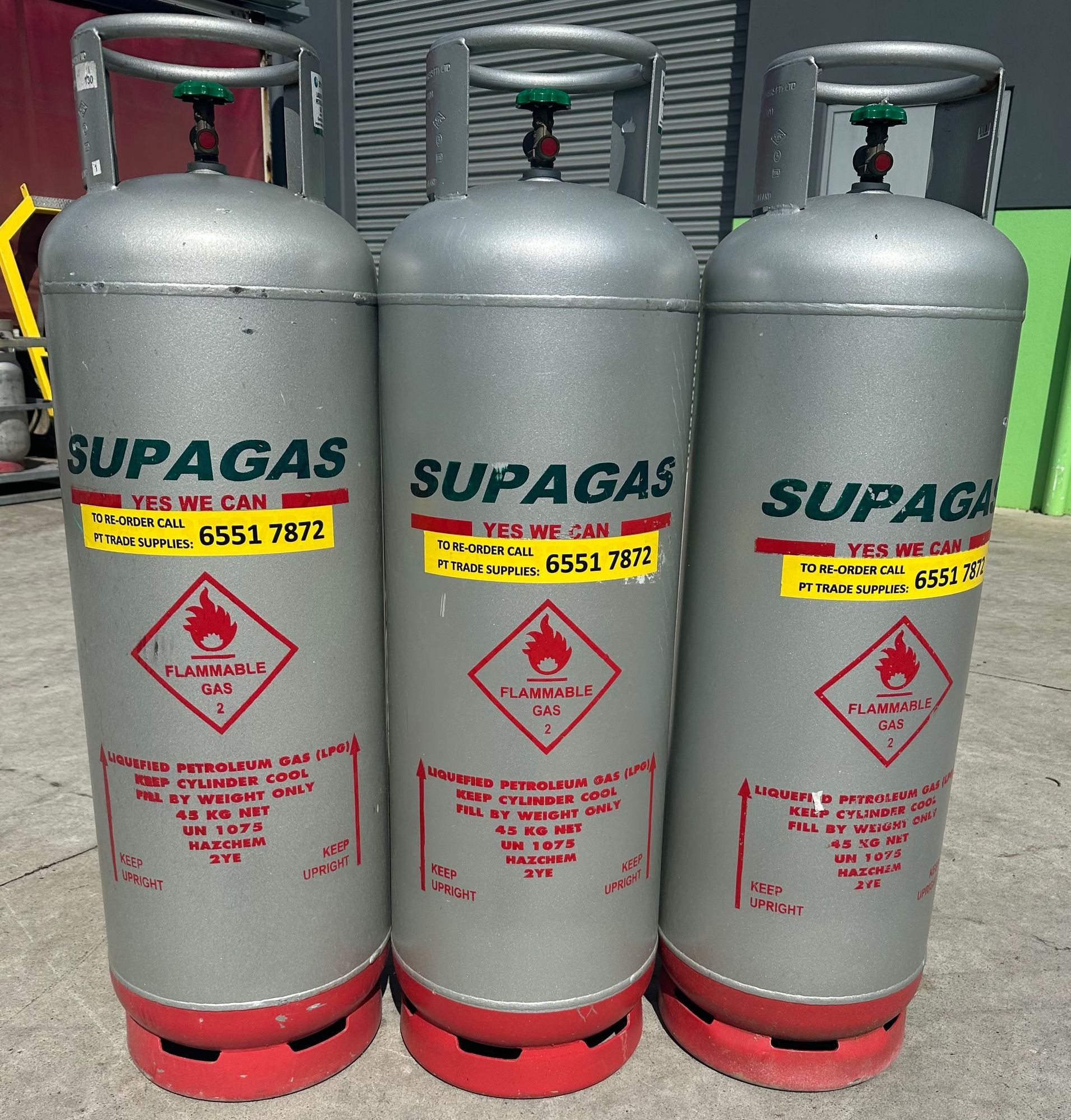 Two Propane Tanks Are Sitting Next To Each Other On The Ground — PT Trade Supplies in Taree, NSW