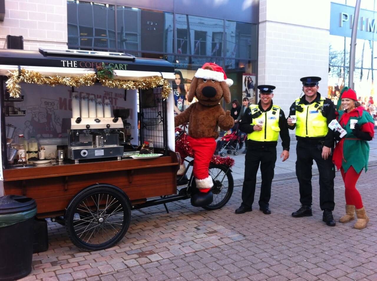 policemen getting a cup of coffee from the coffee cart