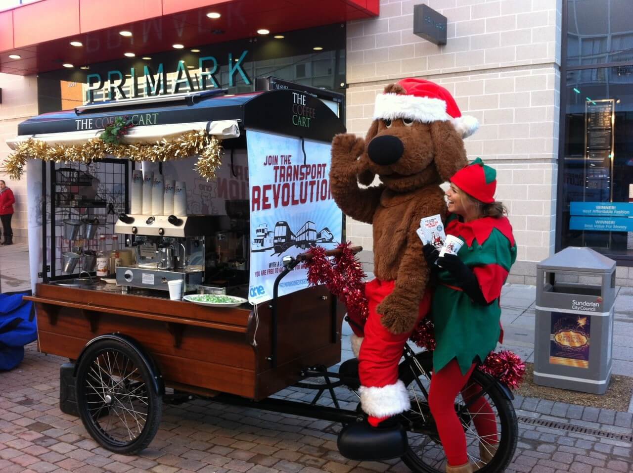 man in dog suit riding the coffee cart