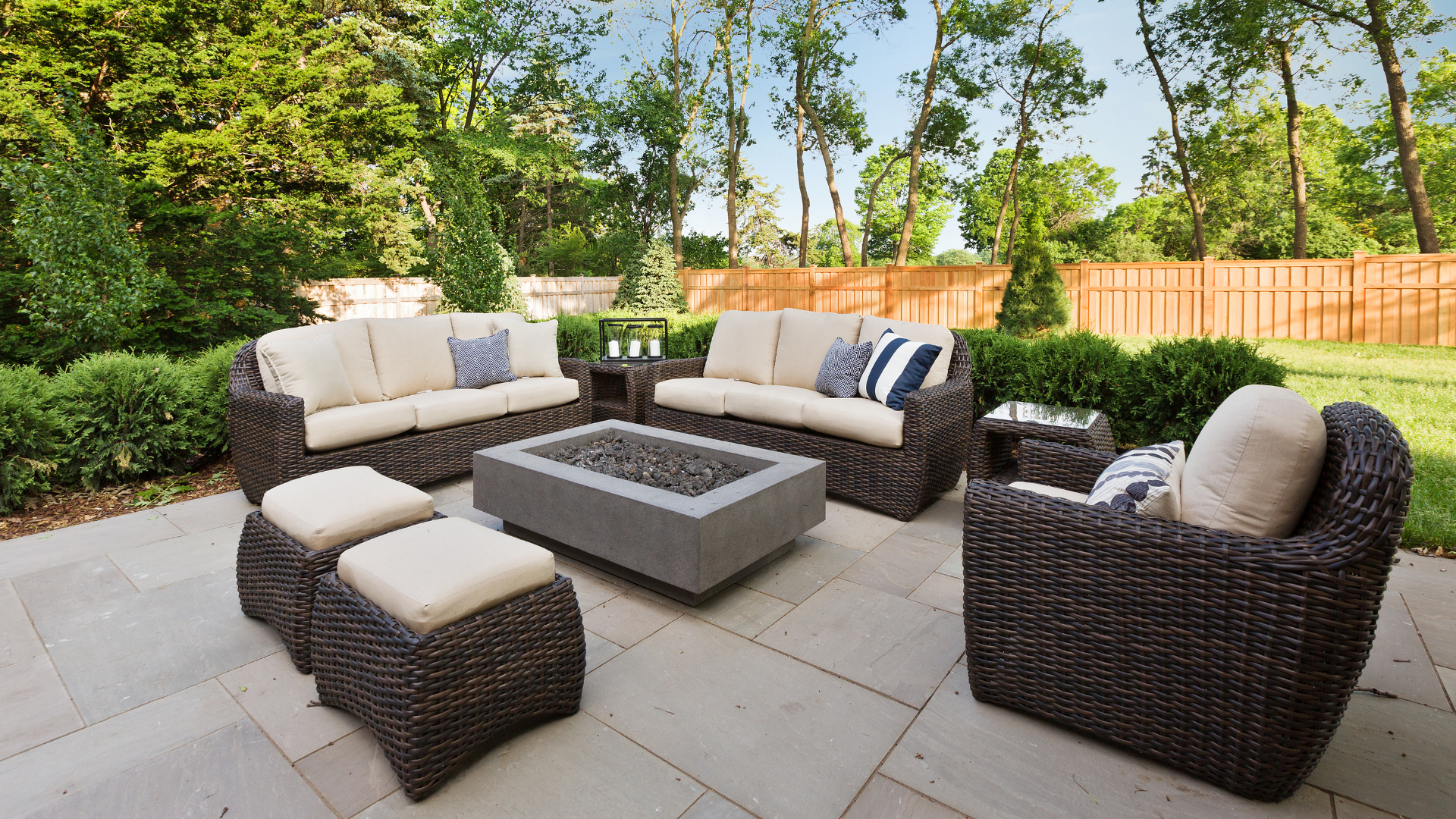 A patio with wicker furniture and a fire pit.
