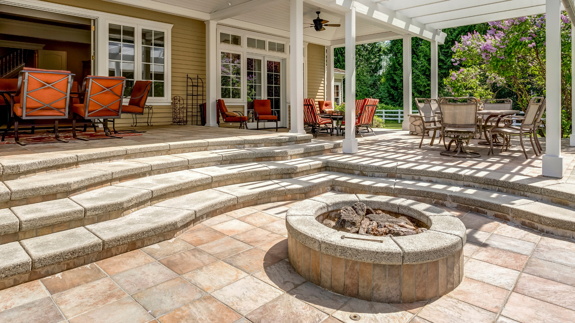 There is a fire pit in the middle of the patio.