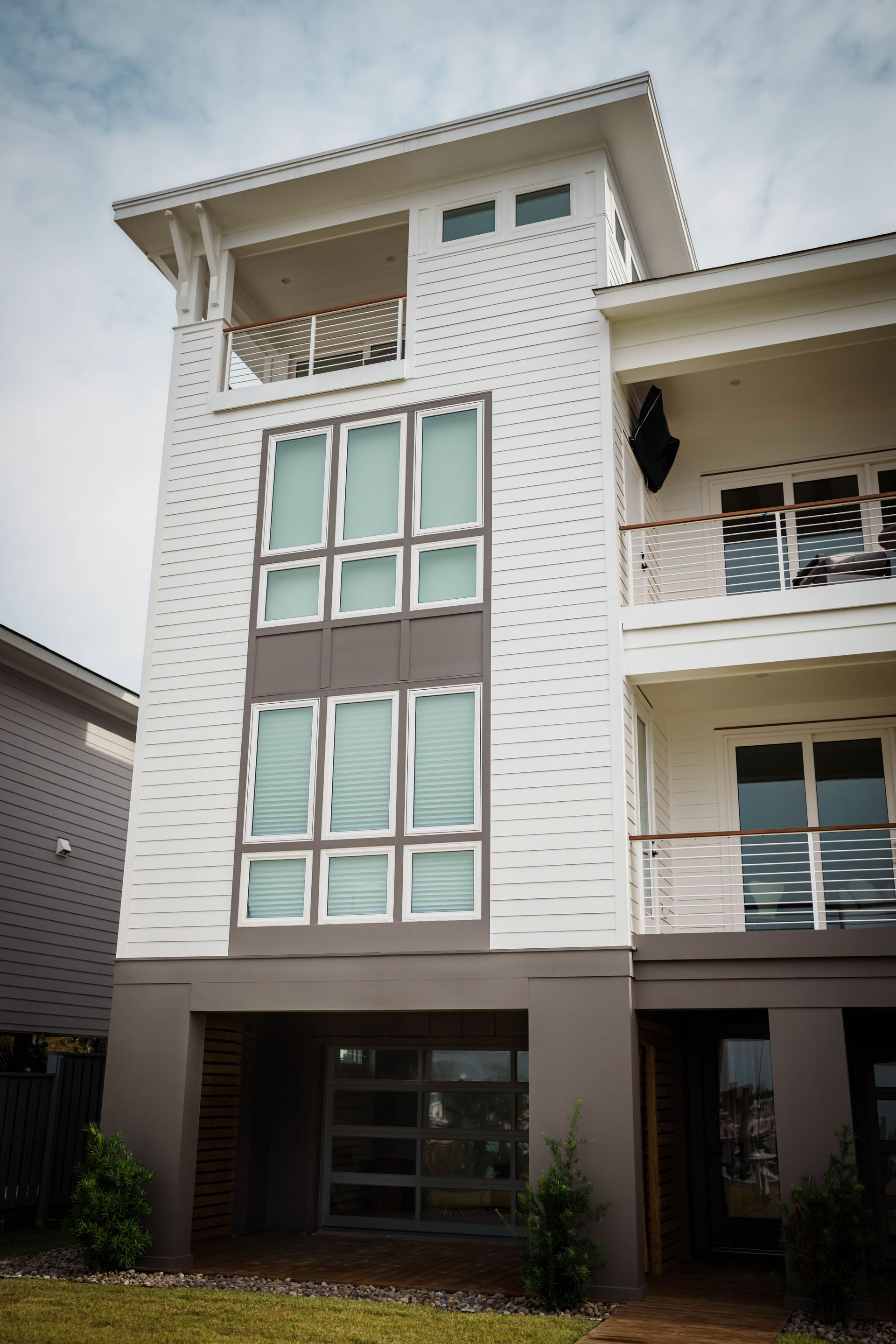 A white house with a lot of windows and balconies