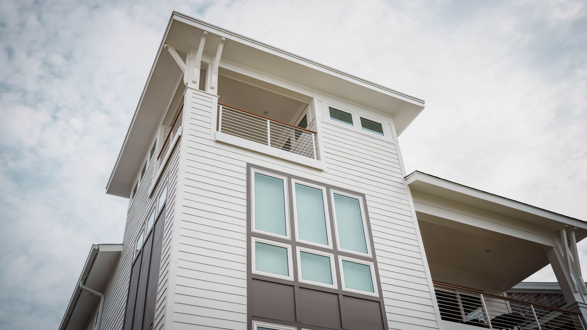 A white building with a balcony on the top of it