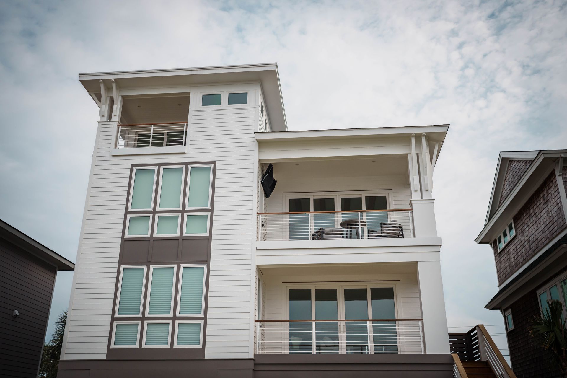 A large white house with lots of windows and balconies