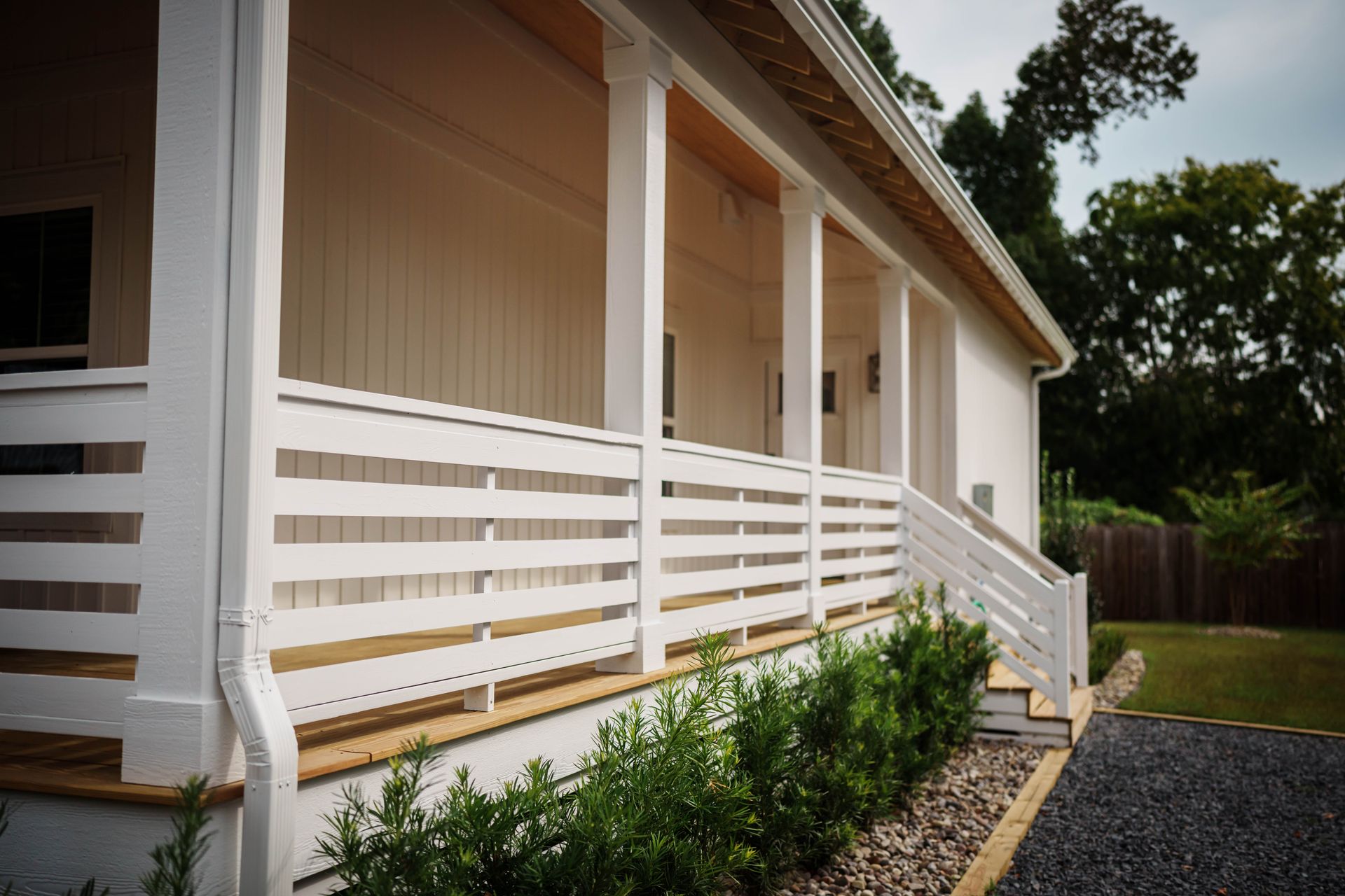 A white house with a porch and stairs
