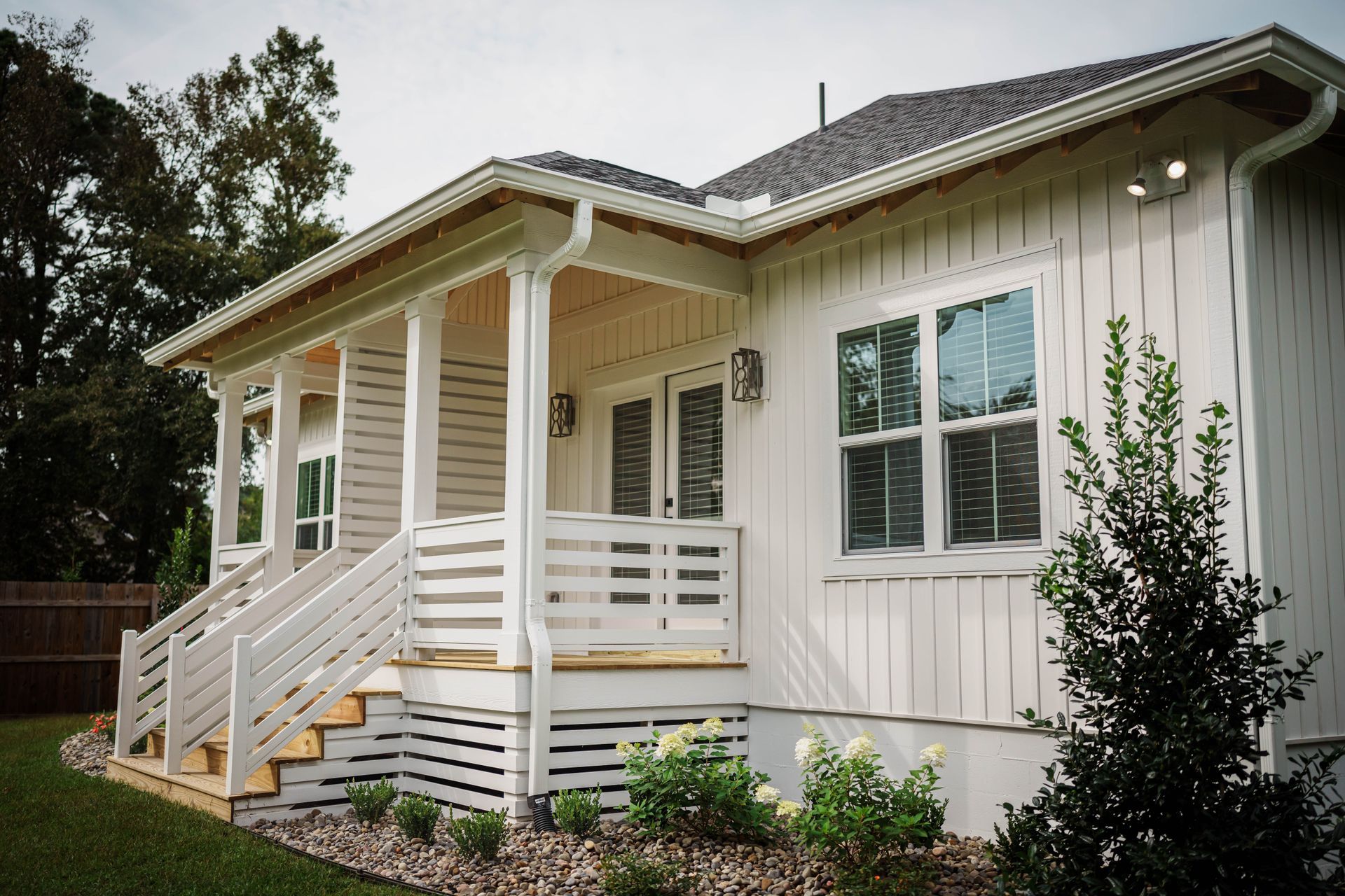 A white house with a porch and stairs