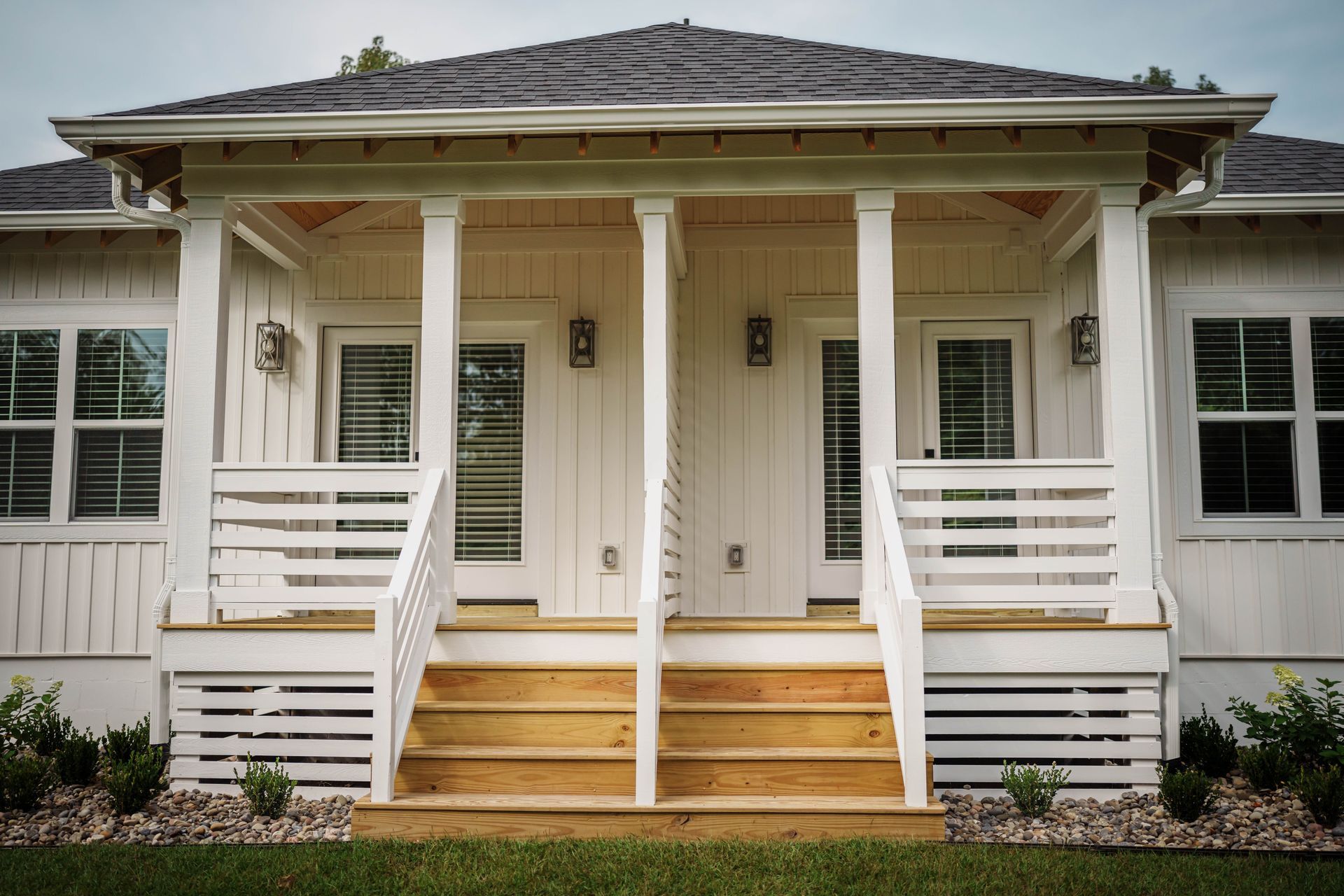 A white house with a porch and stairs