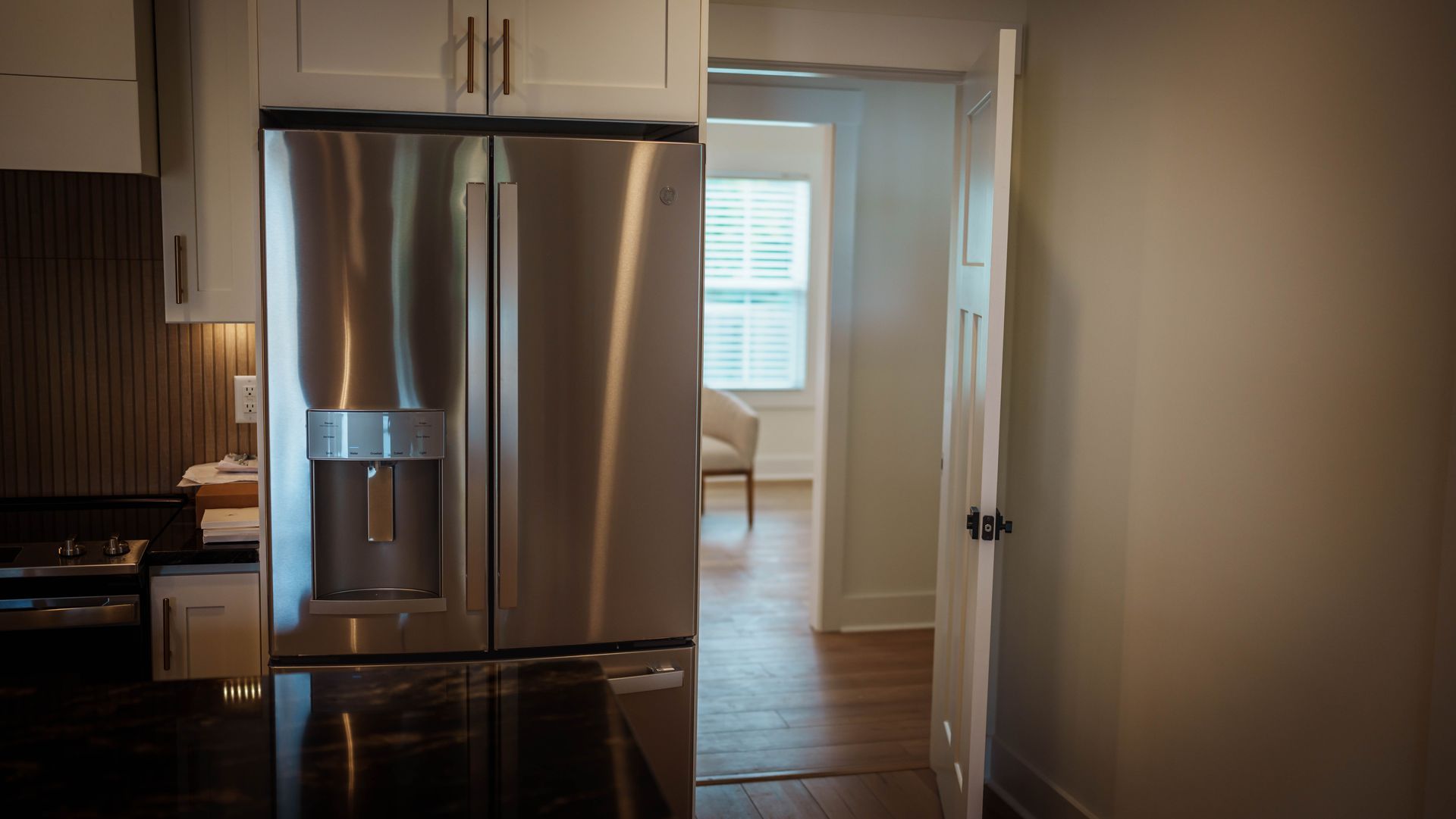 A kitchen with a stainless steel refrigerator and stove