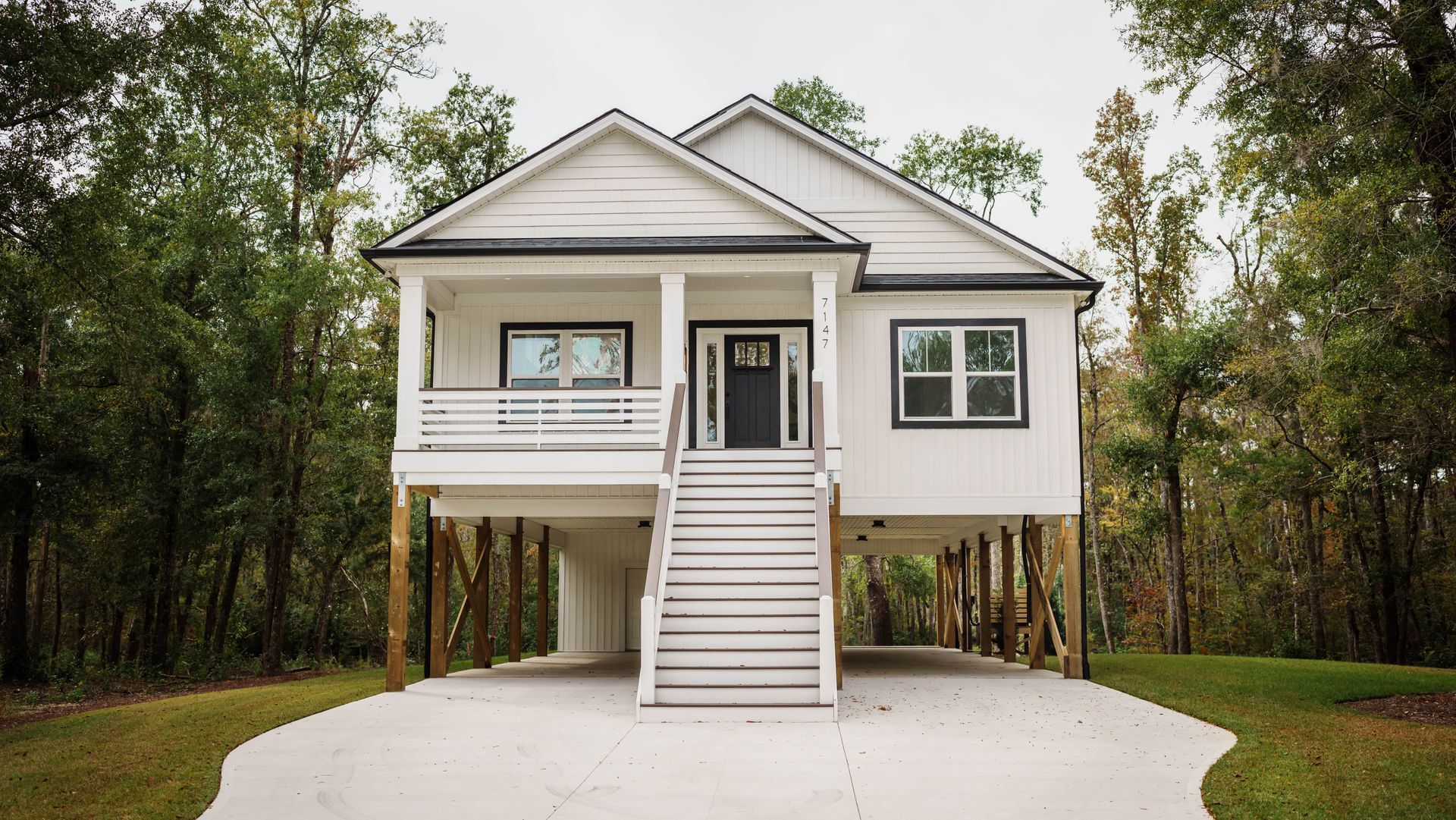 A white house with a black door and stairs