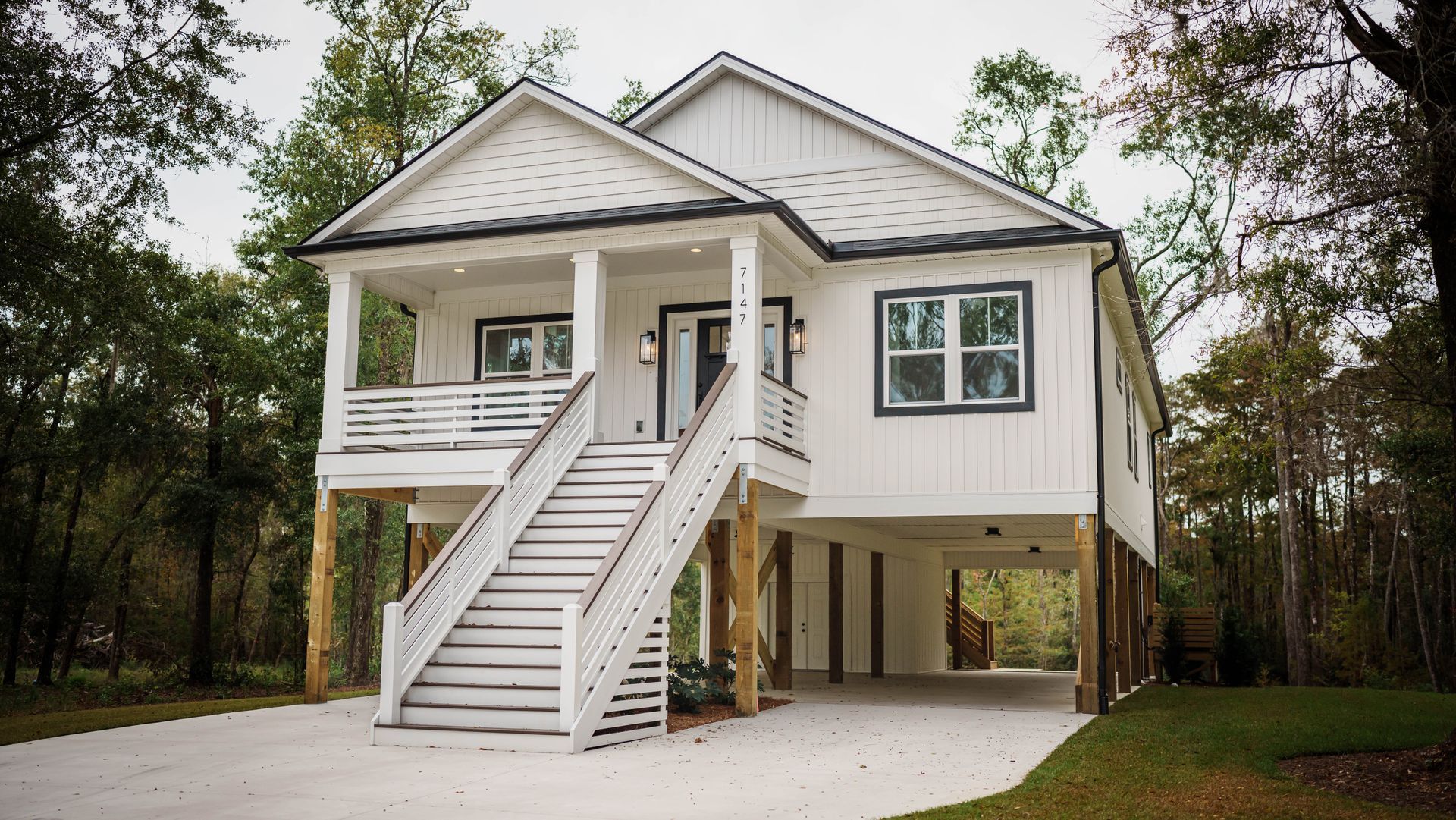 A white house with stairs leading up to the front porch