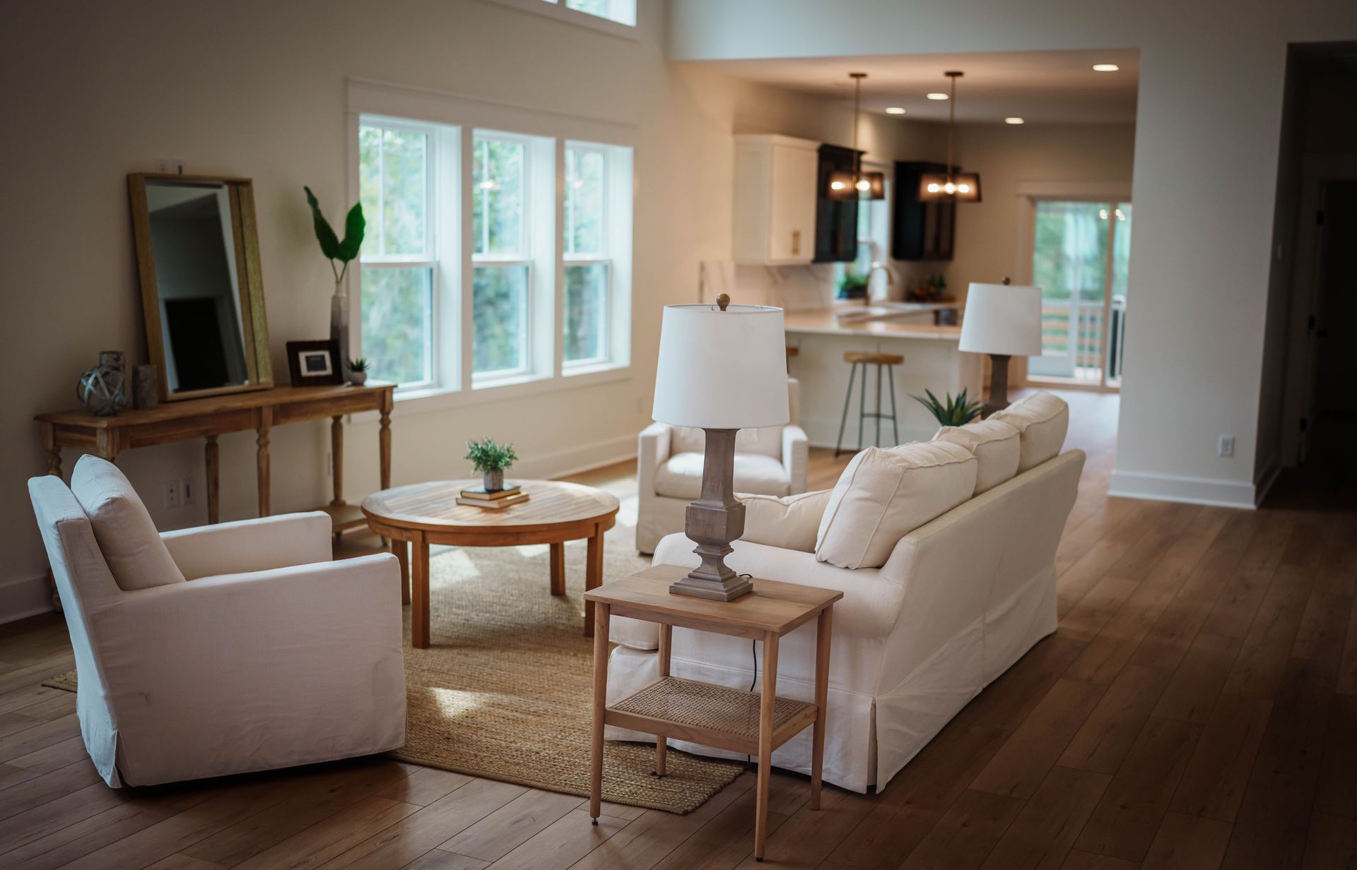 A living room with a white couch and chairs
