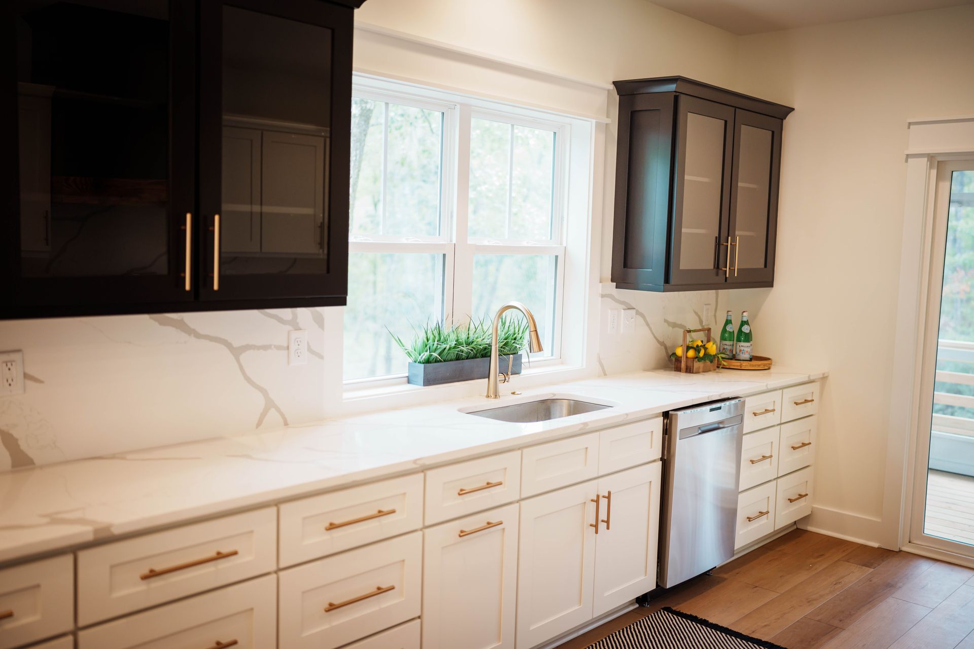 A kitchen with black cabinets and white counter tops
