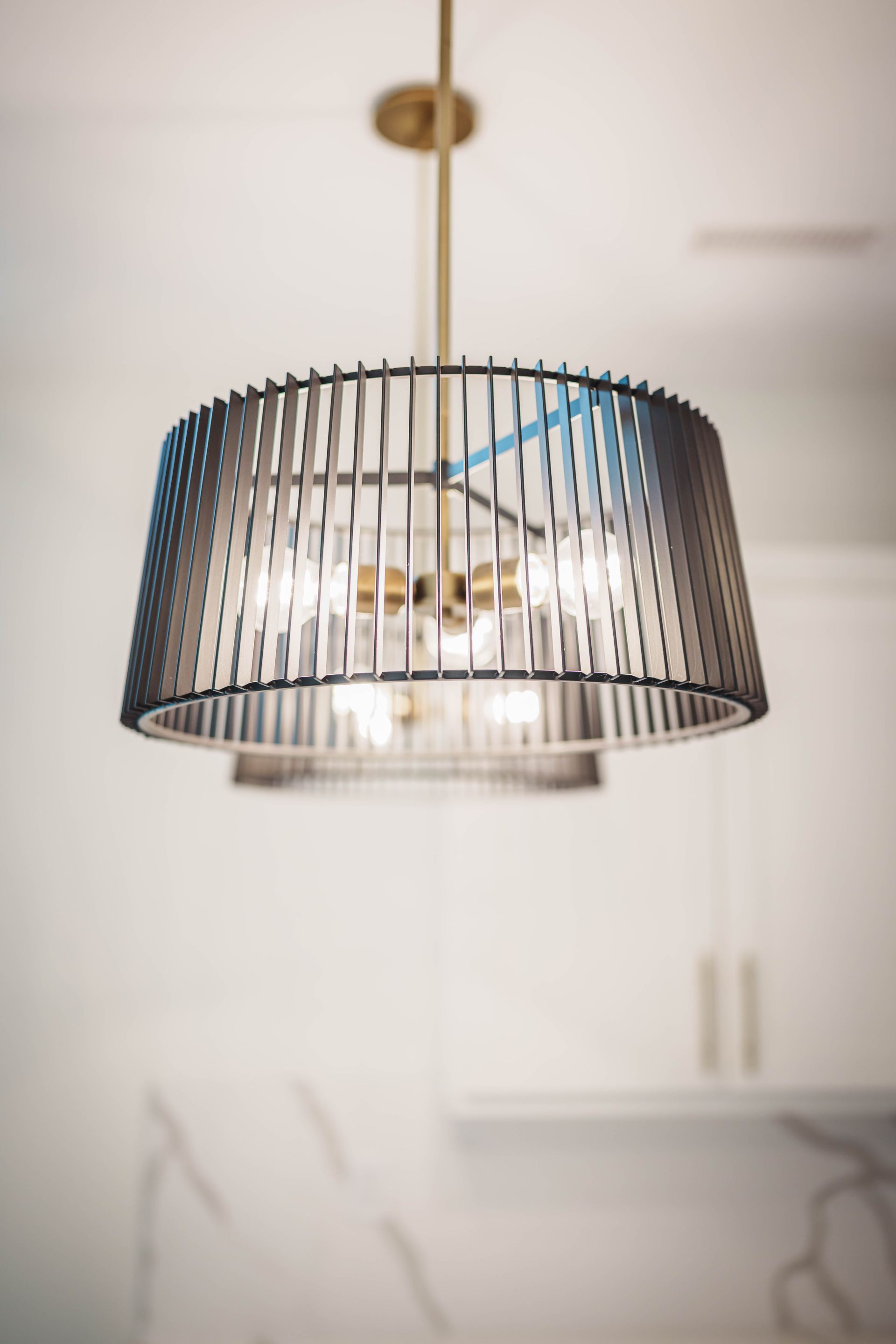 A chandelier is hanging from the ceiling in a kitchen