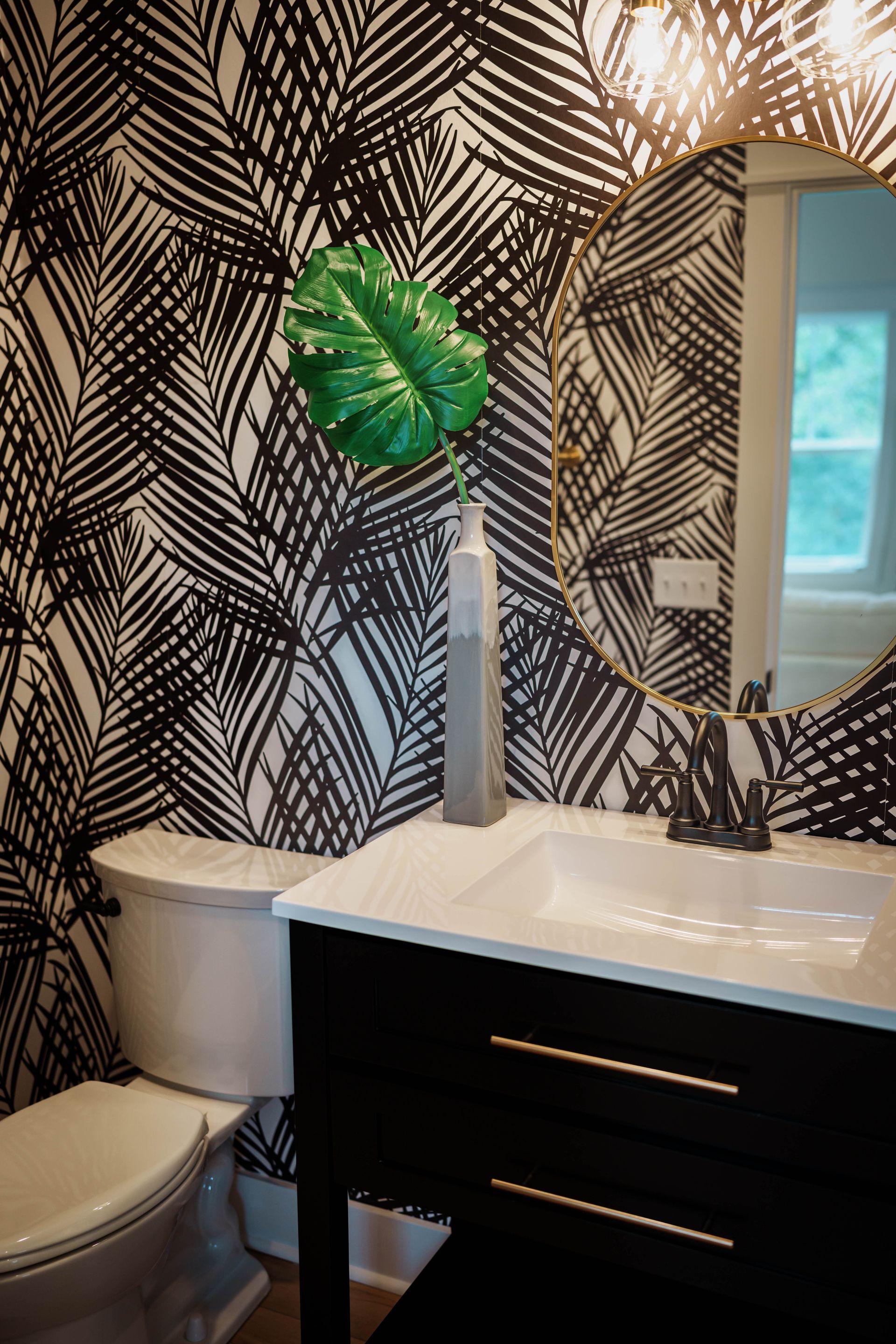 A bathroom with a toilet a sink and a mirror