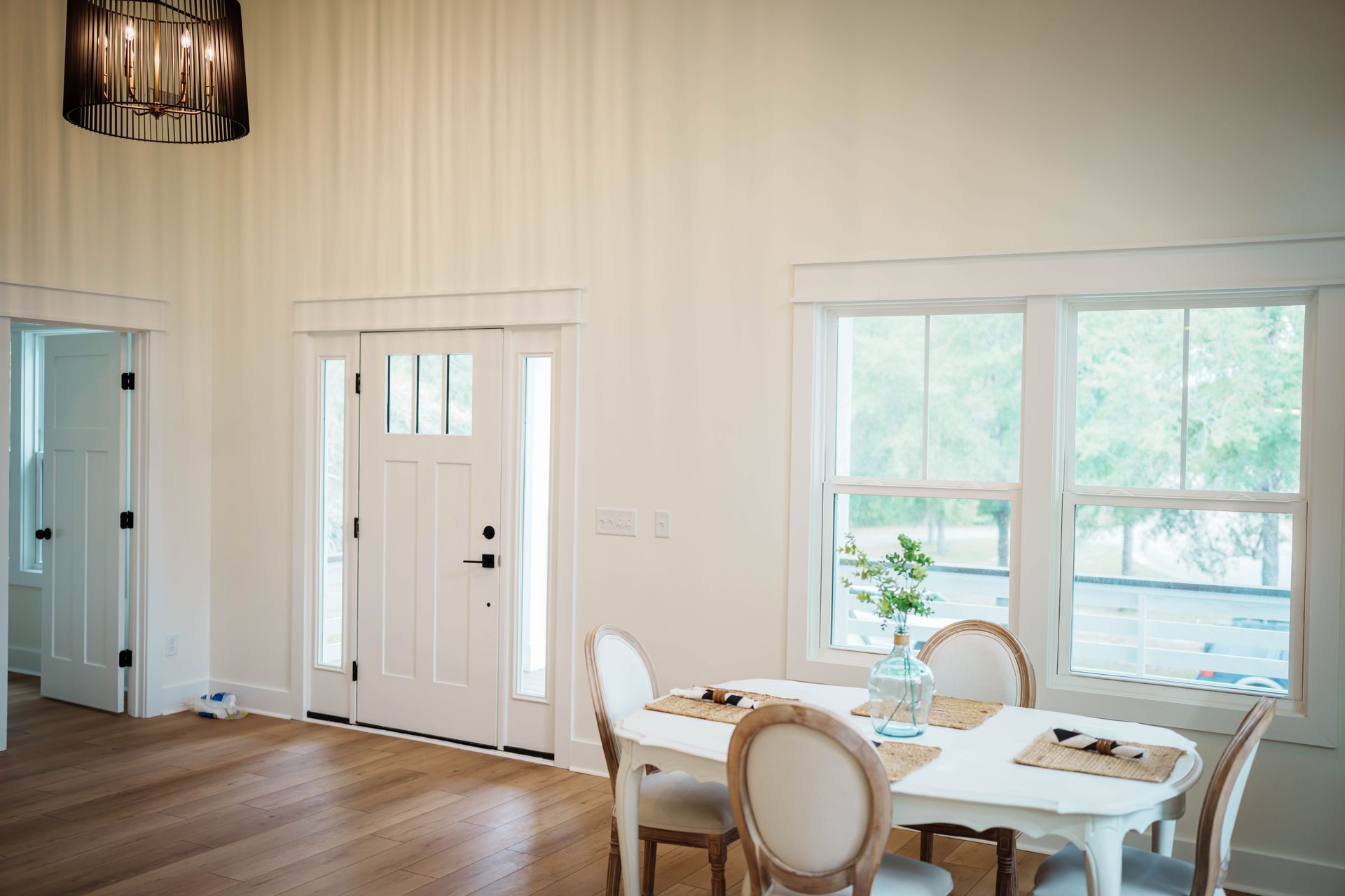 A dining room with a white table and chairs