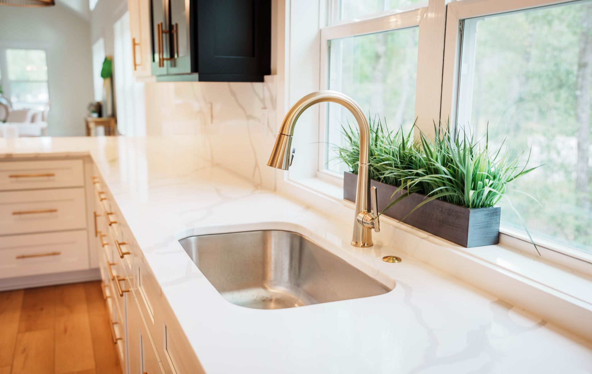 A kitchen with a stainless steel sink and a window