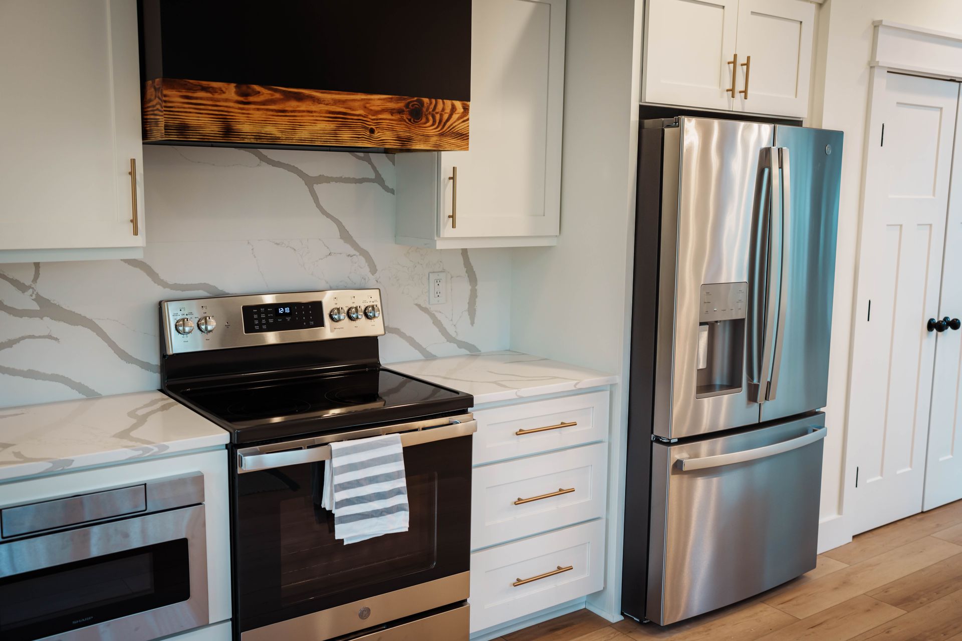 A kitchen with stainless steel appliances and white cabinets