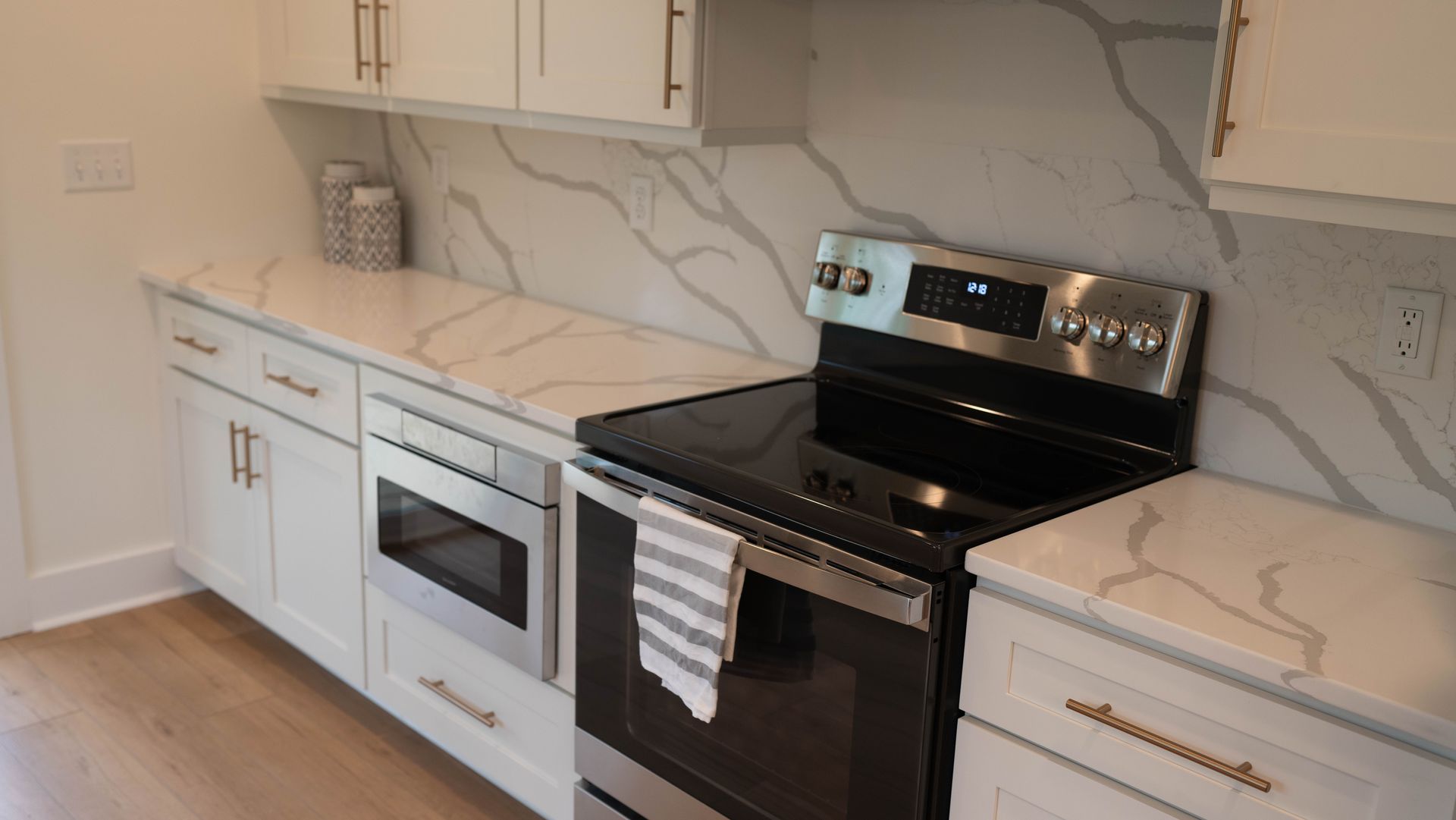 A kitchen with stainless steel appliances and white cabinets