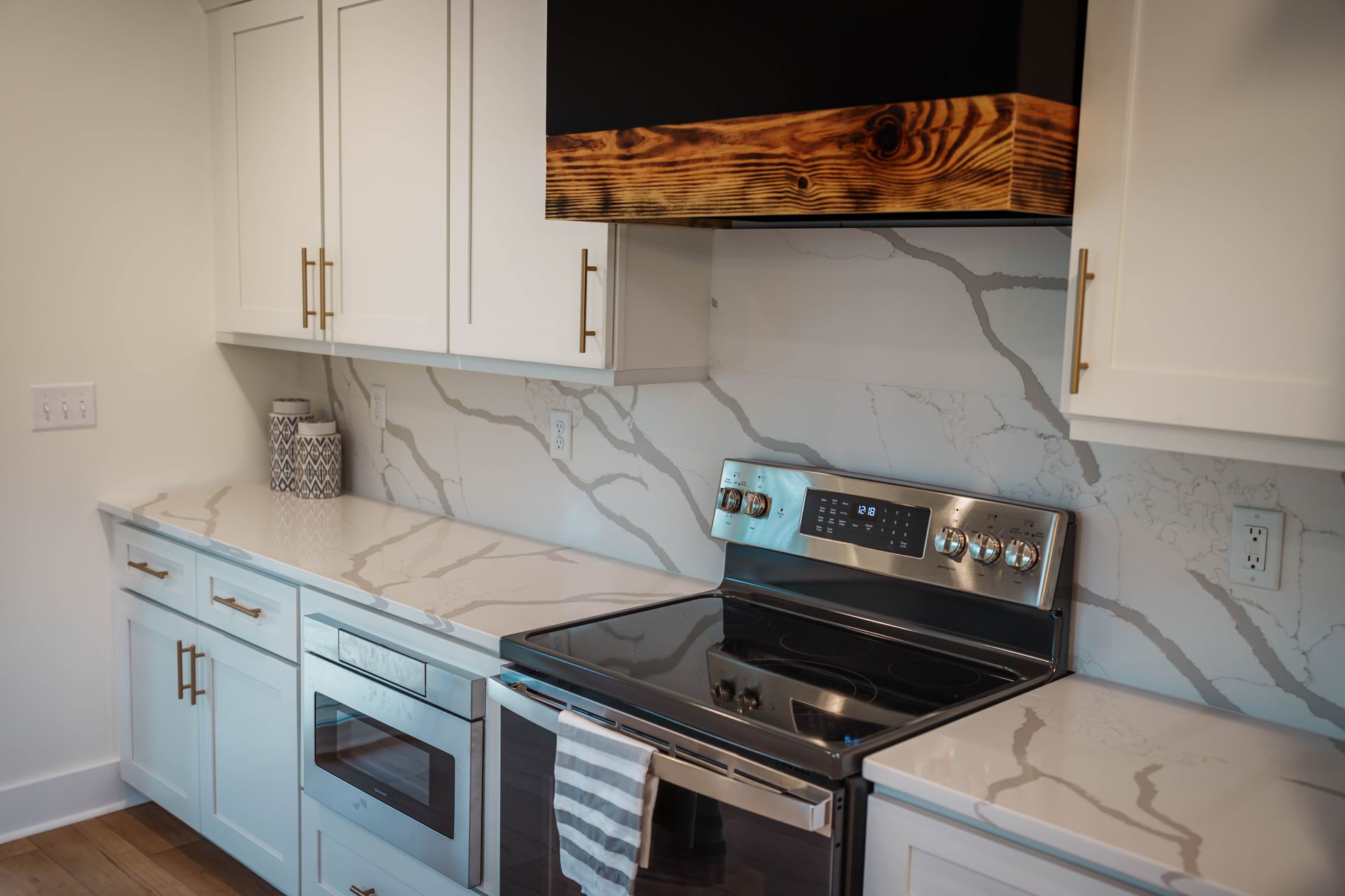 A kitchen with stainless steel appliances and white cabinets