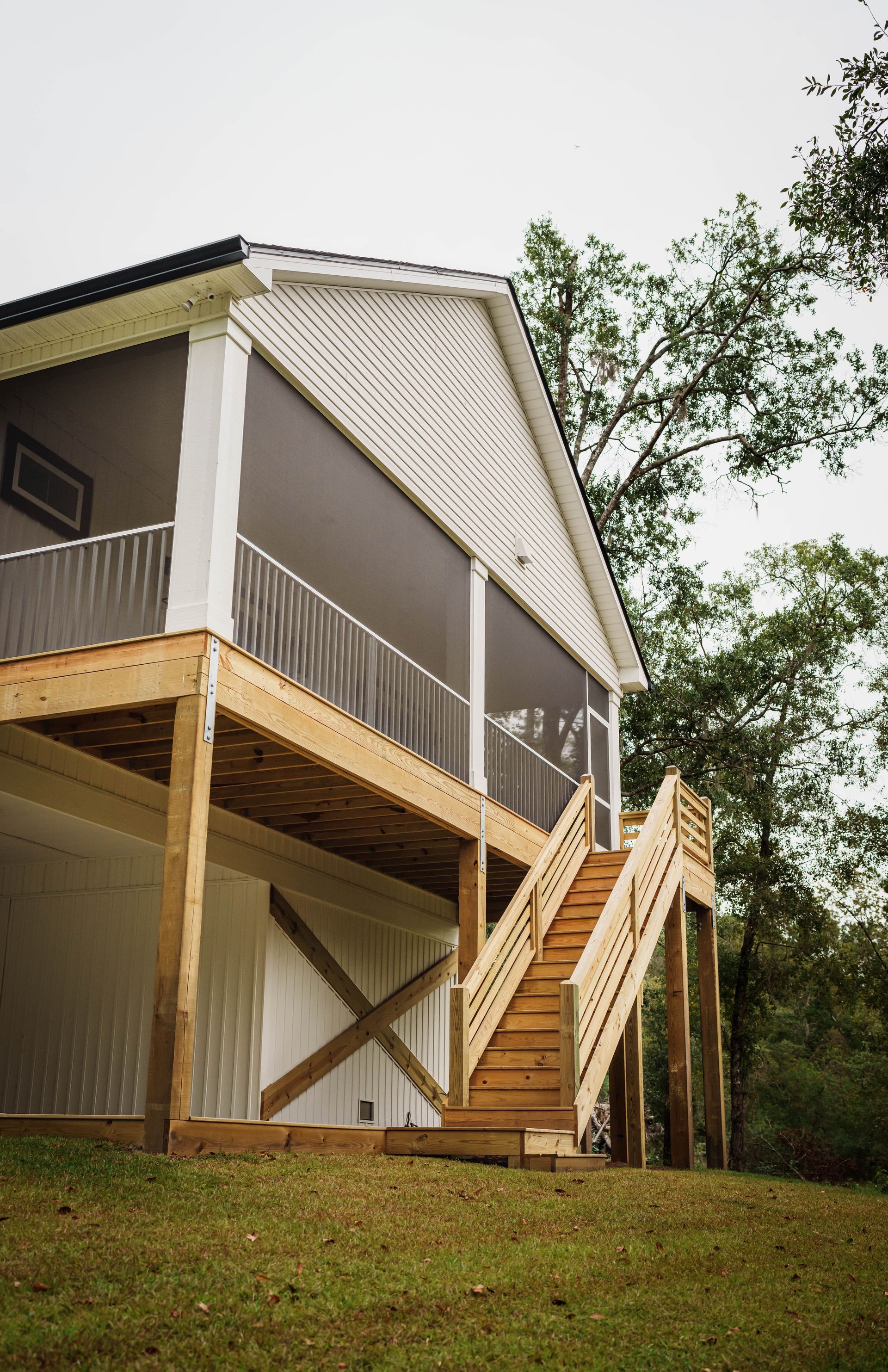 A house with a screened in porch and stairs
