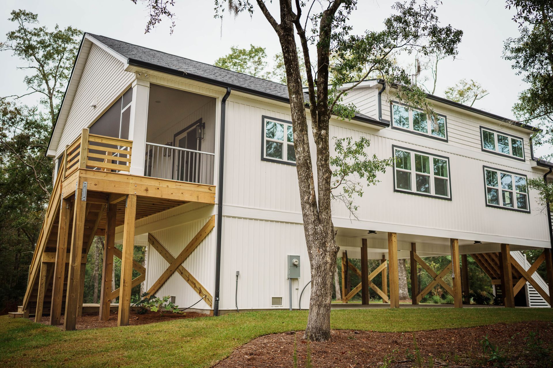 A large white house with a screened in porch