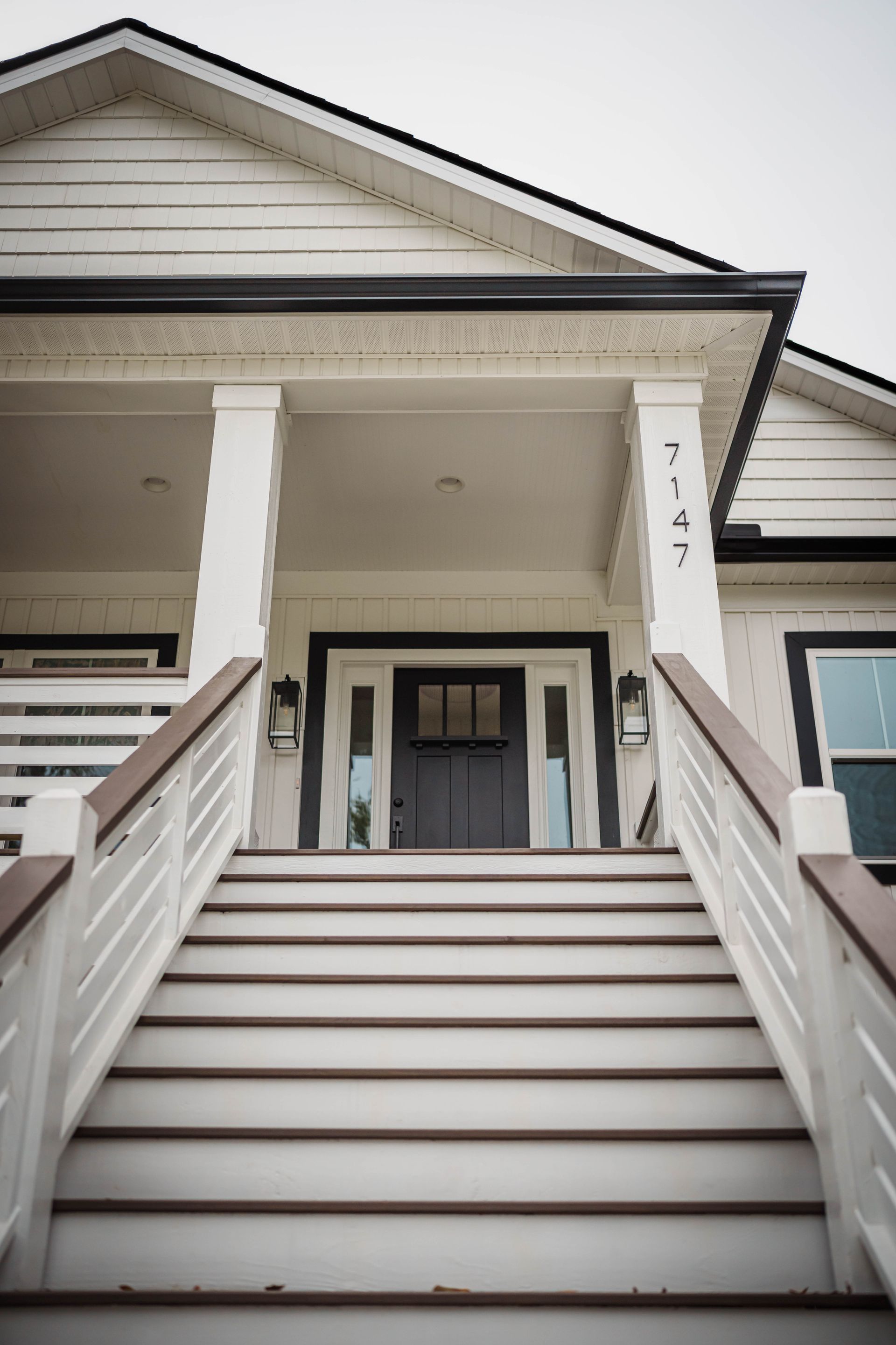 A white house with stairs leading up to the front door