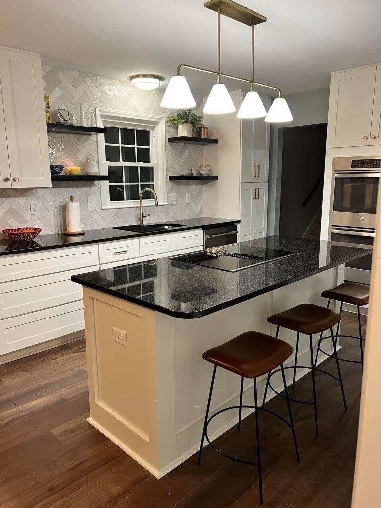 A kitchen with a large island and stools