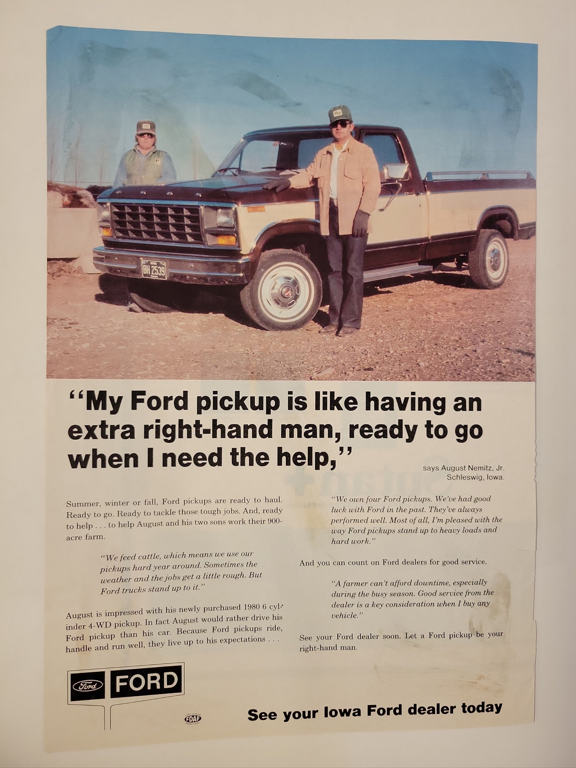 An advertisement for a ford truck shows a man standing next to a truck