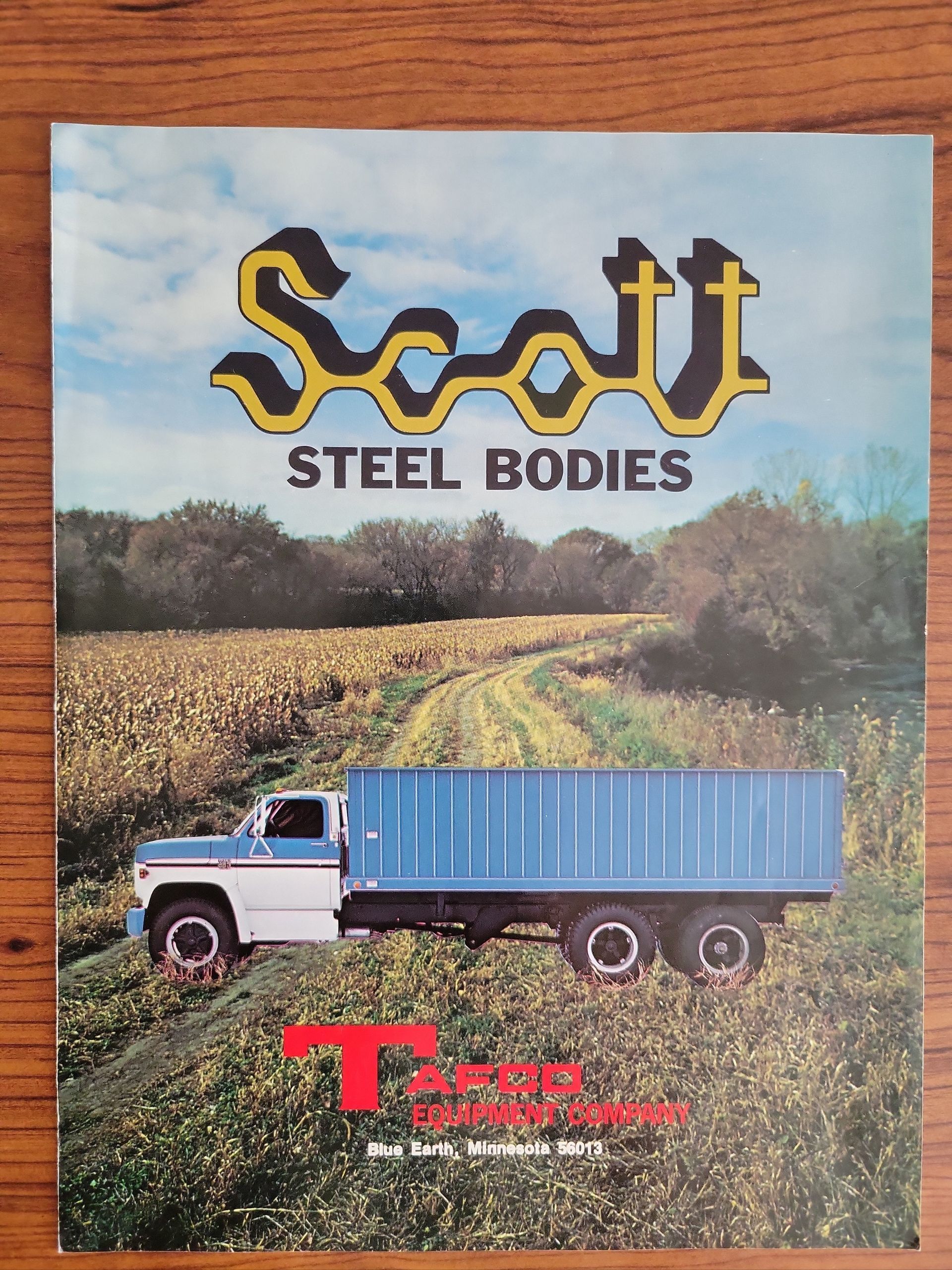 An advertisement for scott steel bodies shows a truck in a field