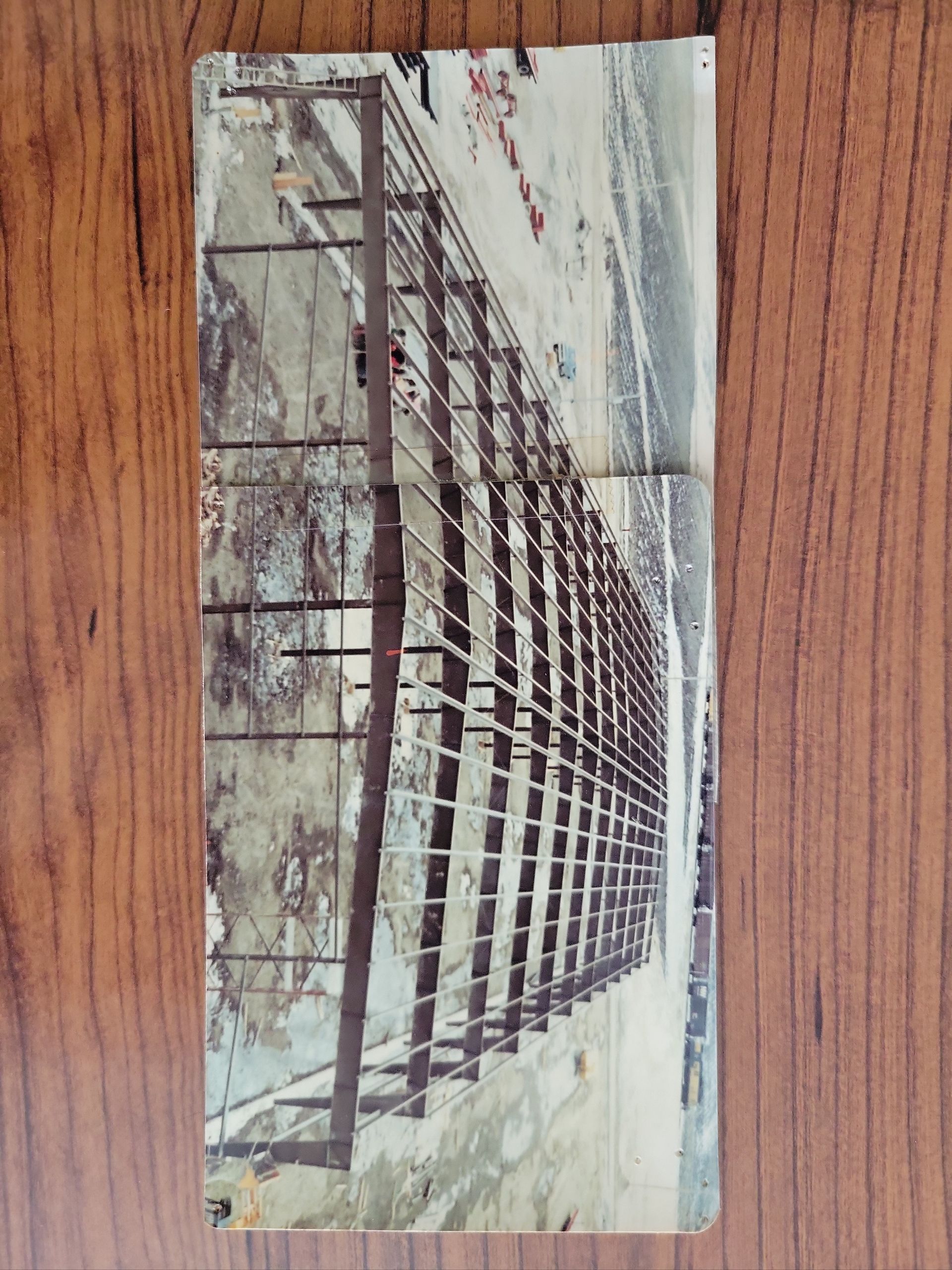 A picture of a building under construction on a wooden table