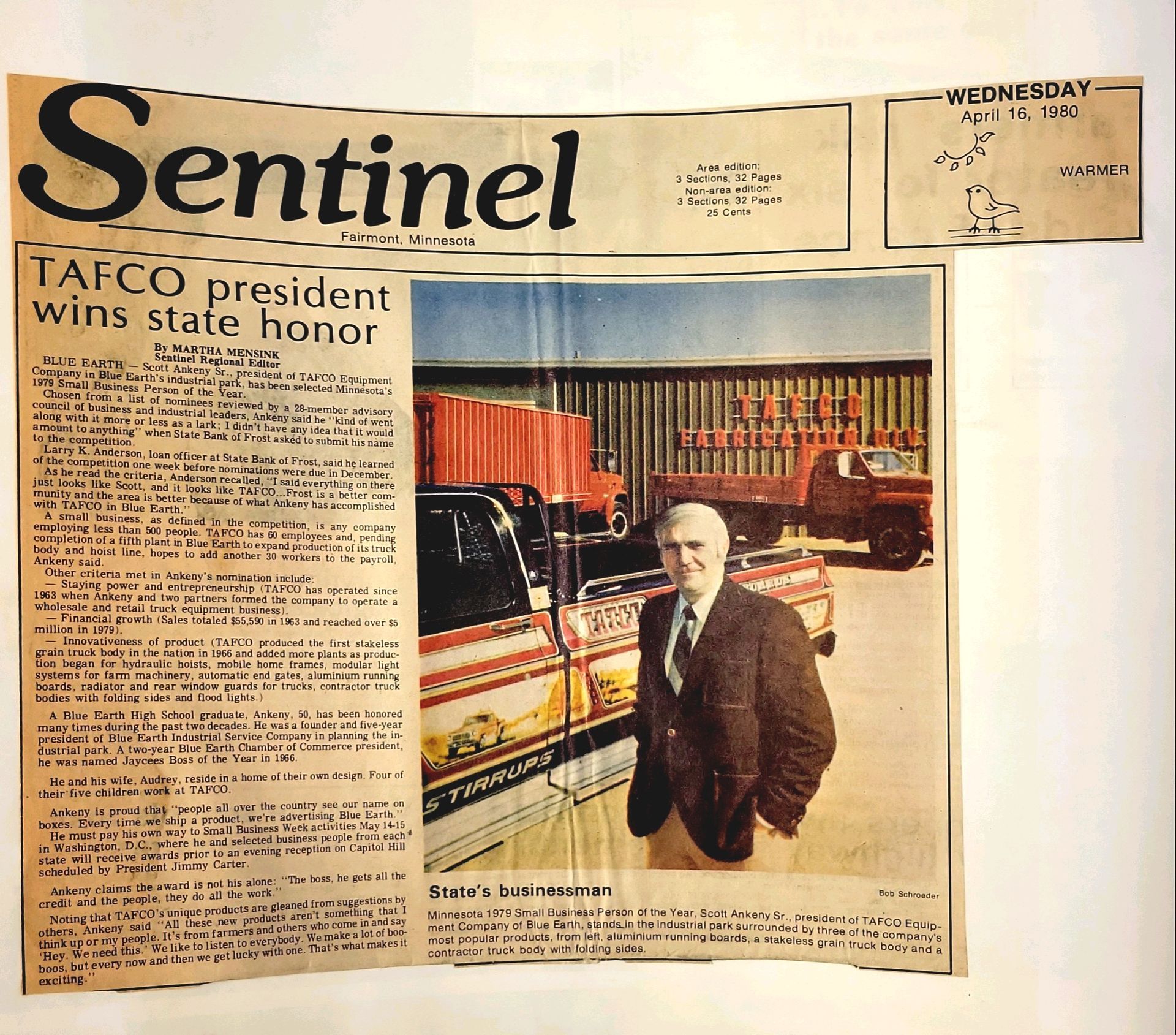 A man in a suit is standing in front of a truck in a newspaper article titled sentinel