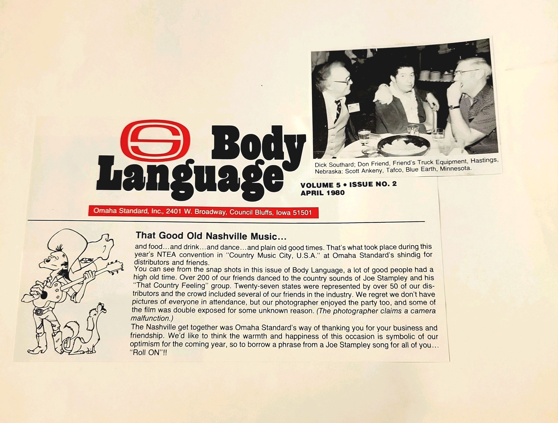 A newspaper article about body language with a picture of people sitting at a table