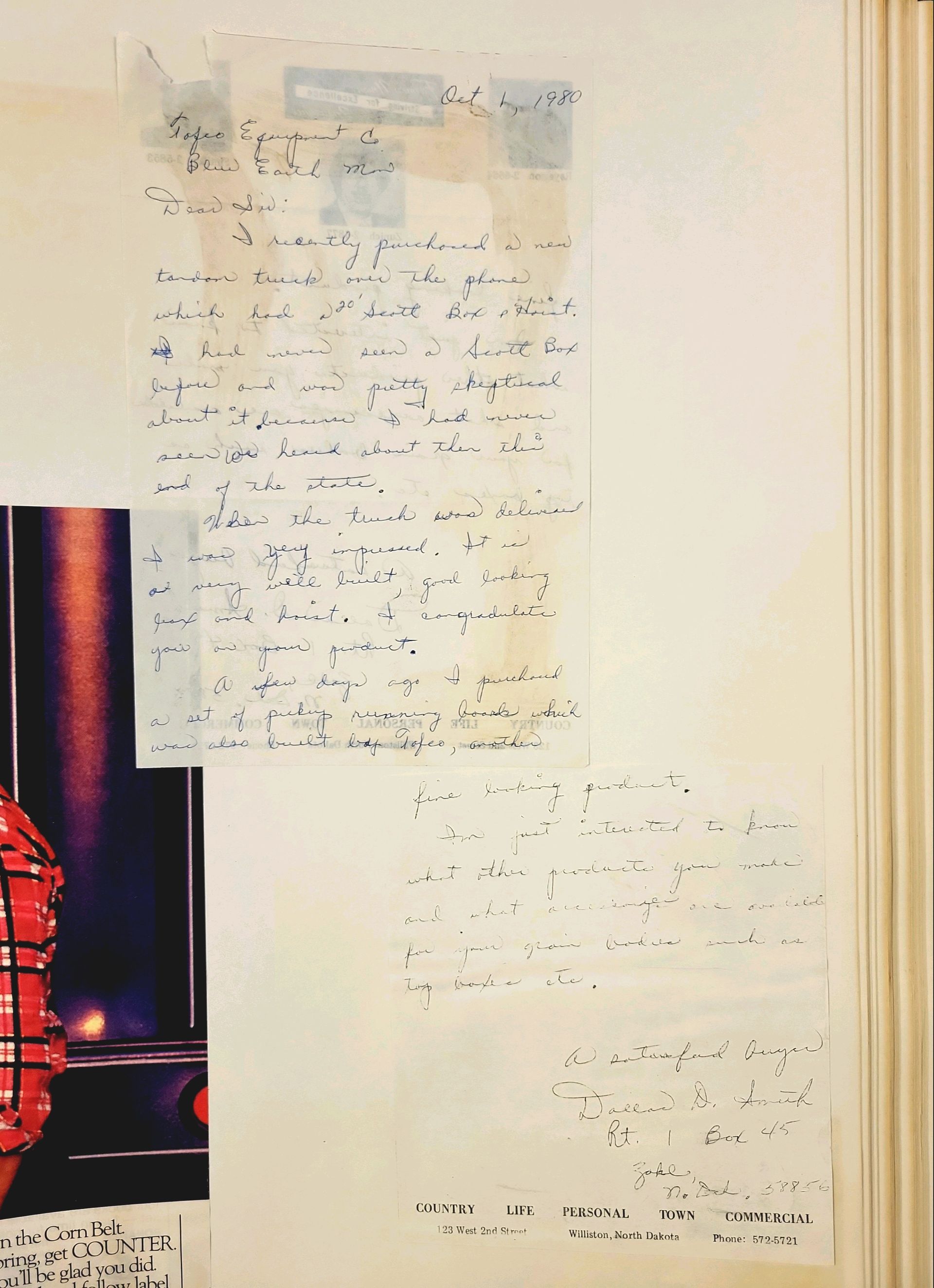 A book is open to a page with a collage of pictures and writing