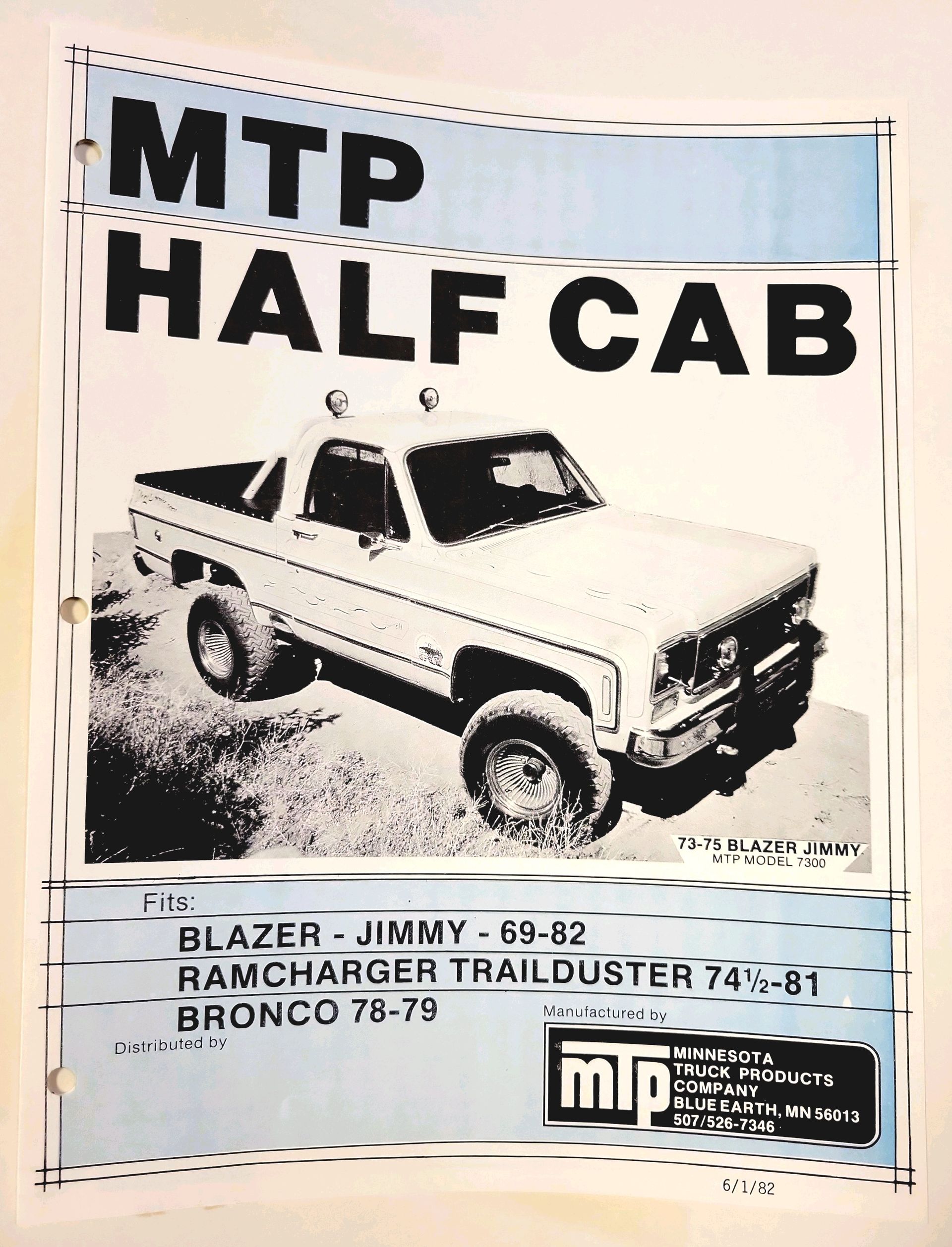 A black and white advertisement for a half cab truck