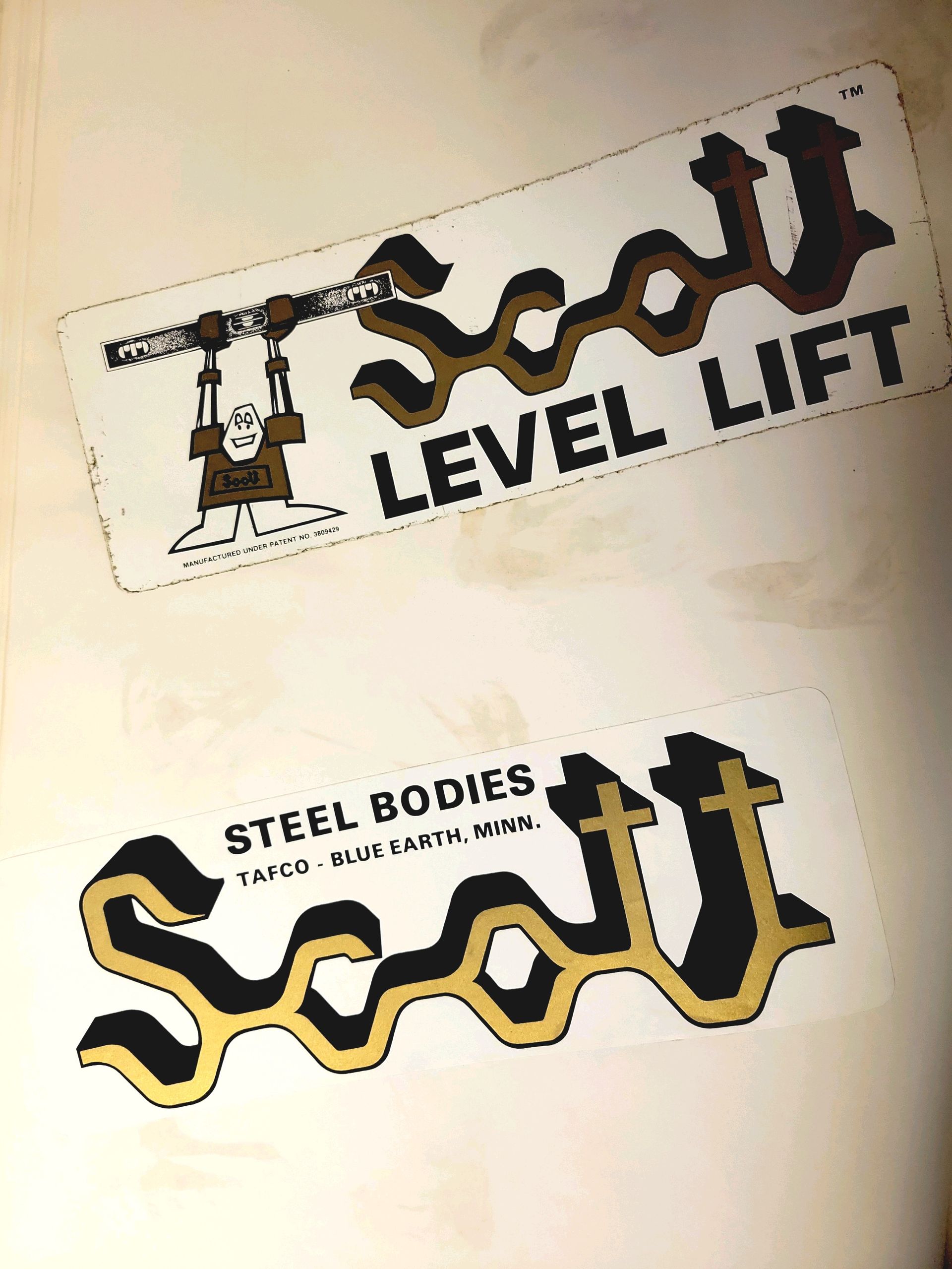 Scott level lift and steel bodies logos on a piece of paper