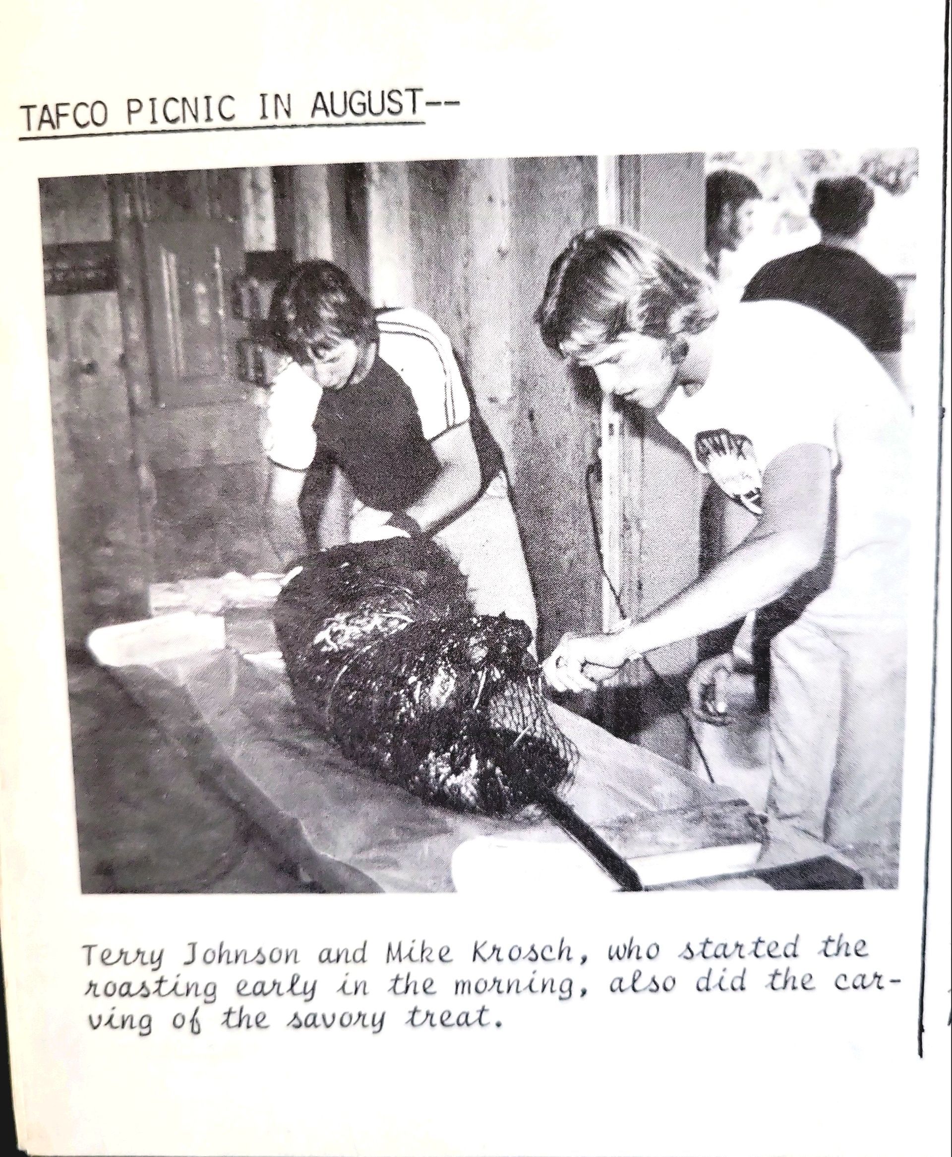 A black and white photo of a picnic in august