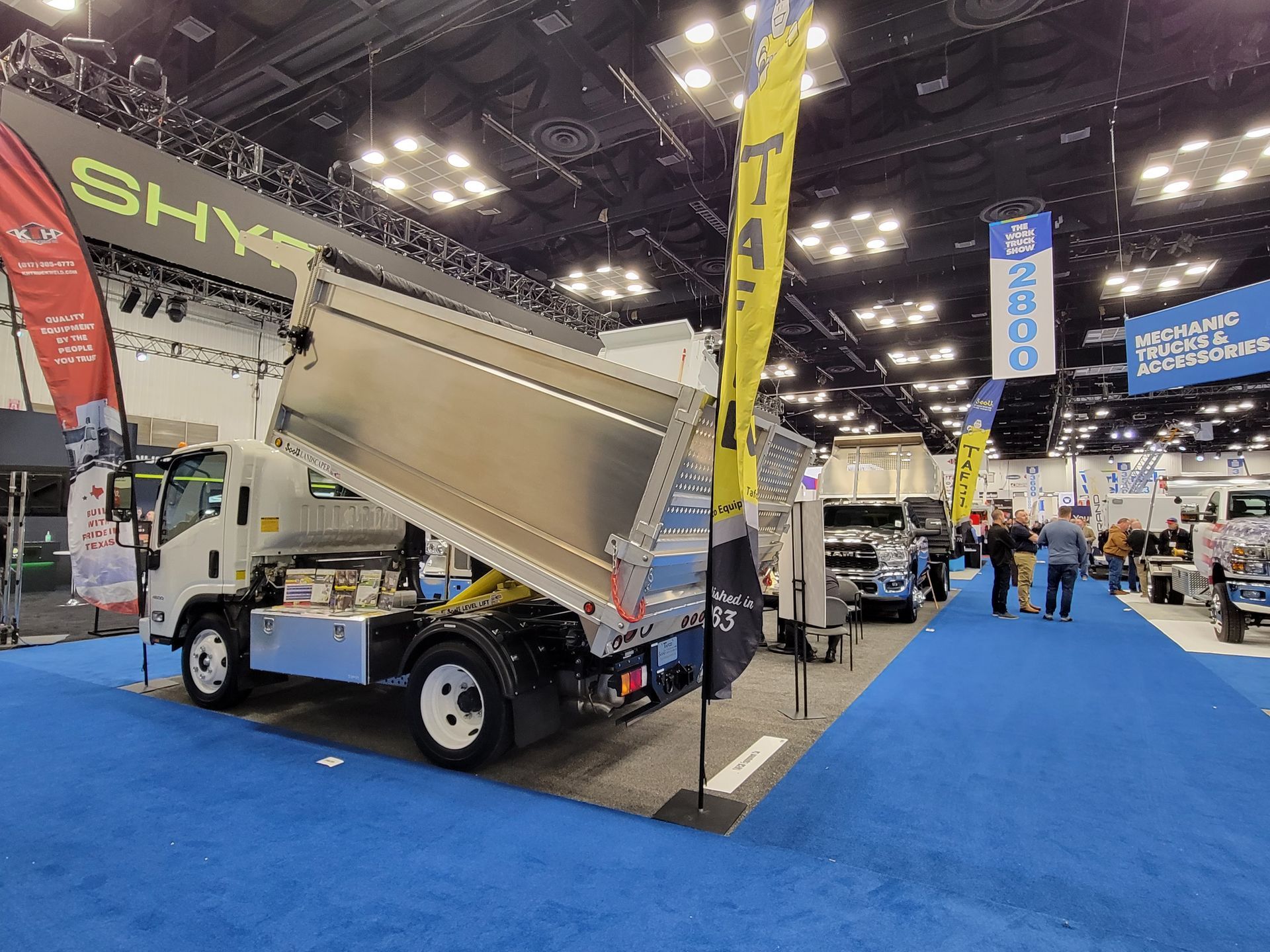 A dump truck is on display at a truck show.